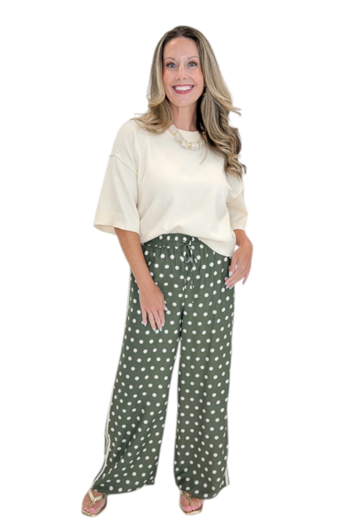 Front view of woman wearing Swagger Boutiqueās Cream 3/4 Sleeve Lightweight Sweater by Entro with Olive Polka Dot Stripe Trim Pants by Entro against white studio background.