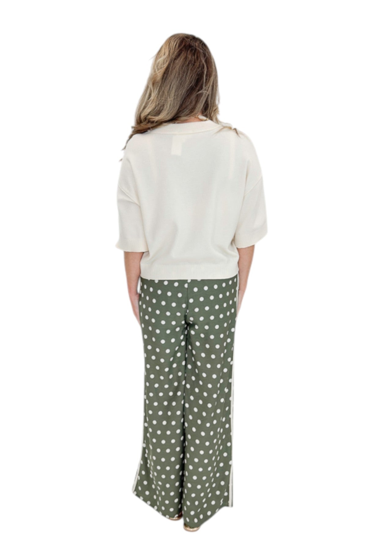 Back view of woman wearing Swagger Boutiqueās Cream 3/4 Sleeve Lightweight Sweater by Entro with Olive Polka Dot Stripe Trim Pants by Entro against white studio background.