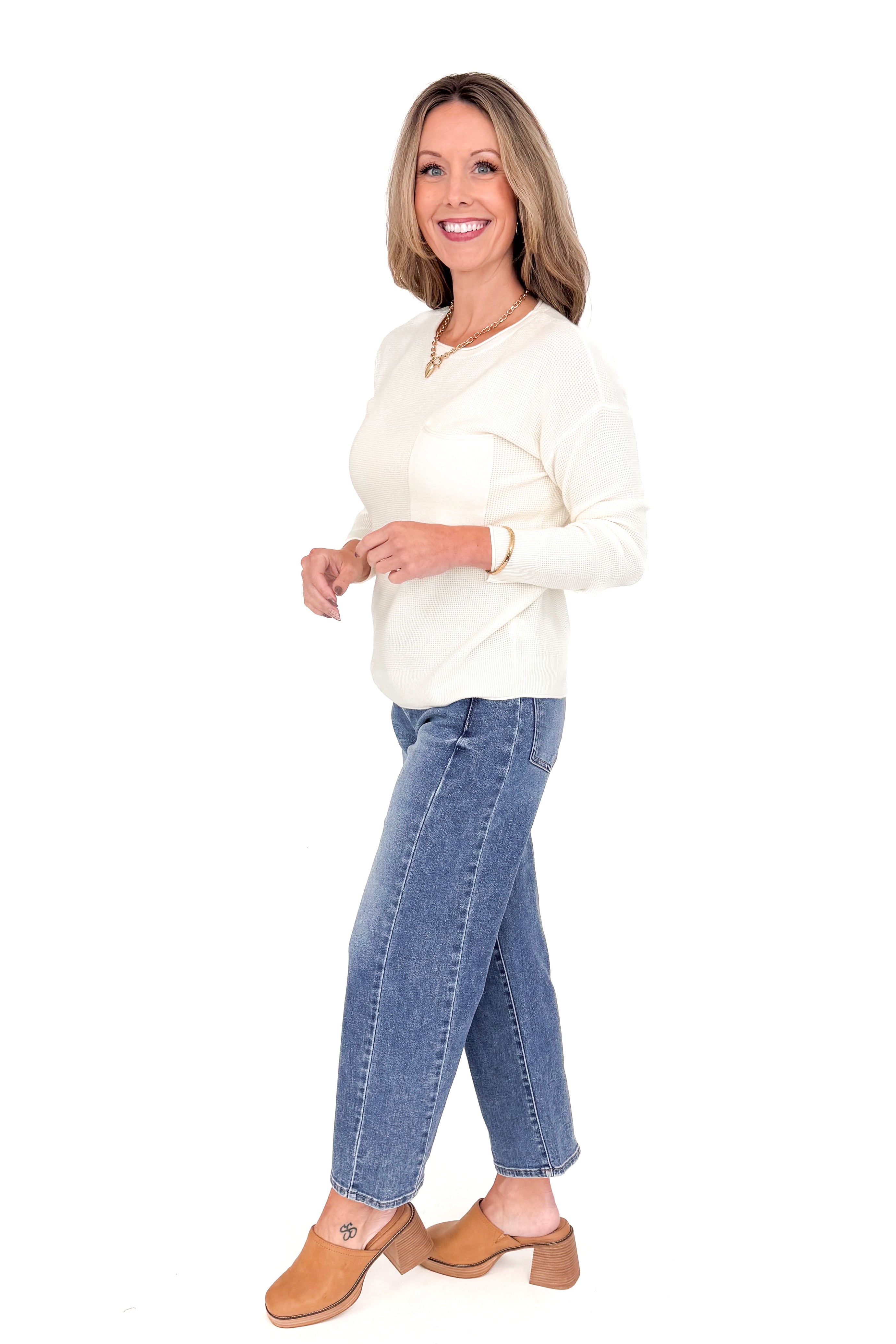 Katie medium wash adjustable waist barrel jeans by Risen - side profile view against white studio background.
