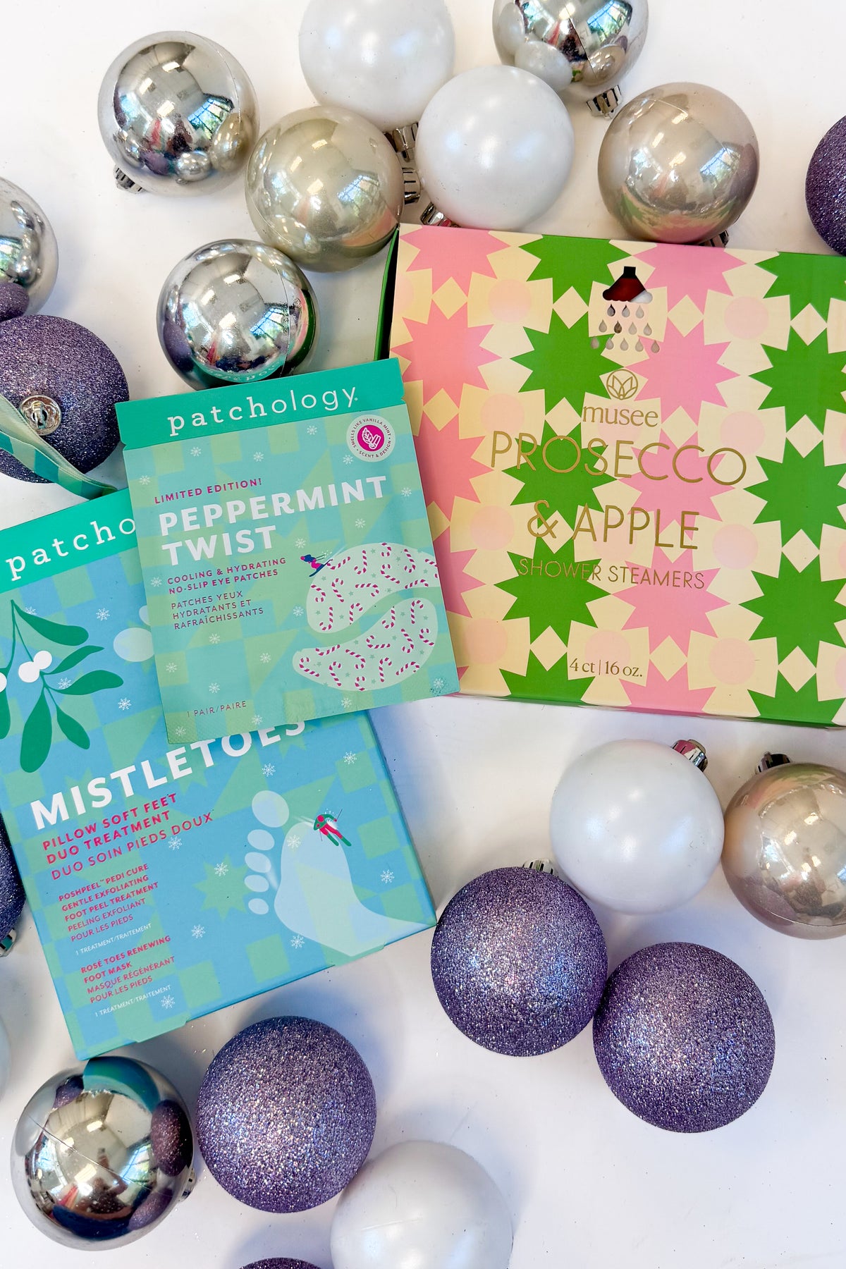 Christmas Shower Steamers & Patchology against holiday background.