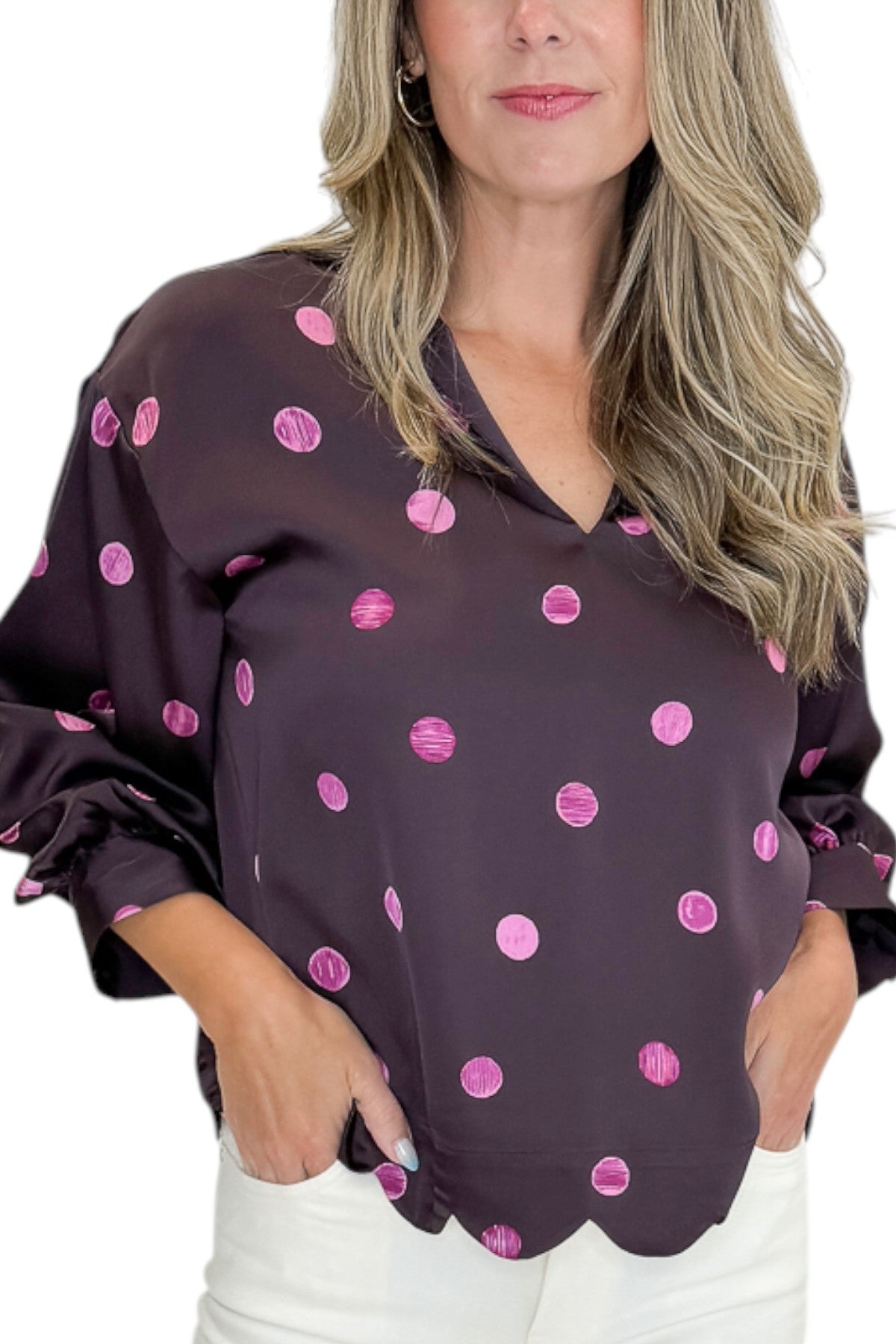 Front detail view of woman wearing Swagger Boutiqueās Plum & Pink Polka Dot 3/4 Sleeve Top by Entro with jeans against white studio background.