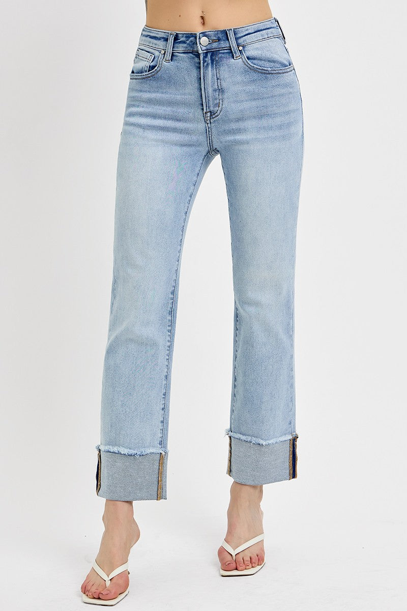 Front view of woman wearing sweater with Light Wash Relaxed Straight Jeans by Risen against white studio background.