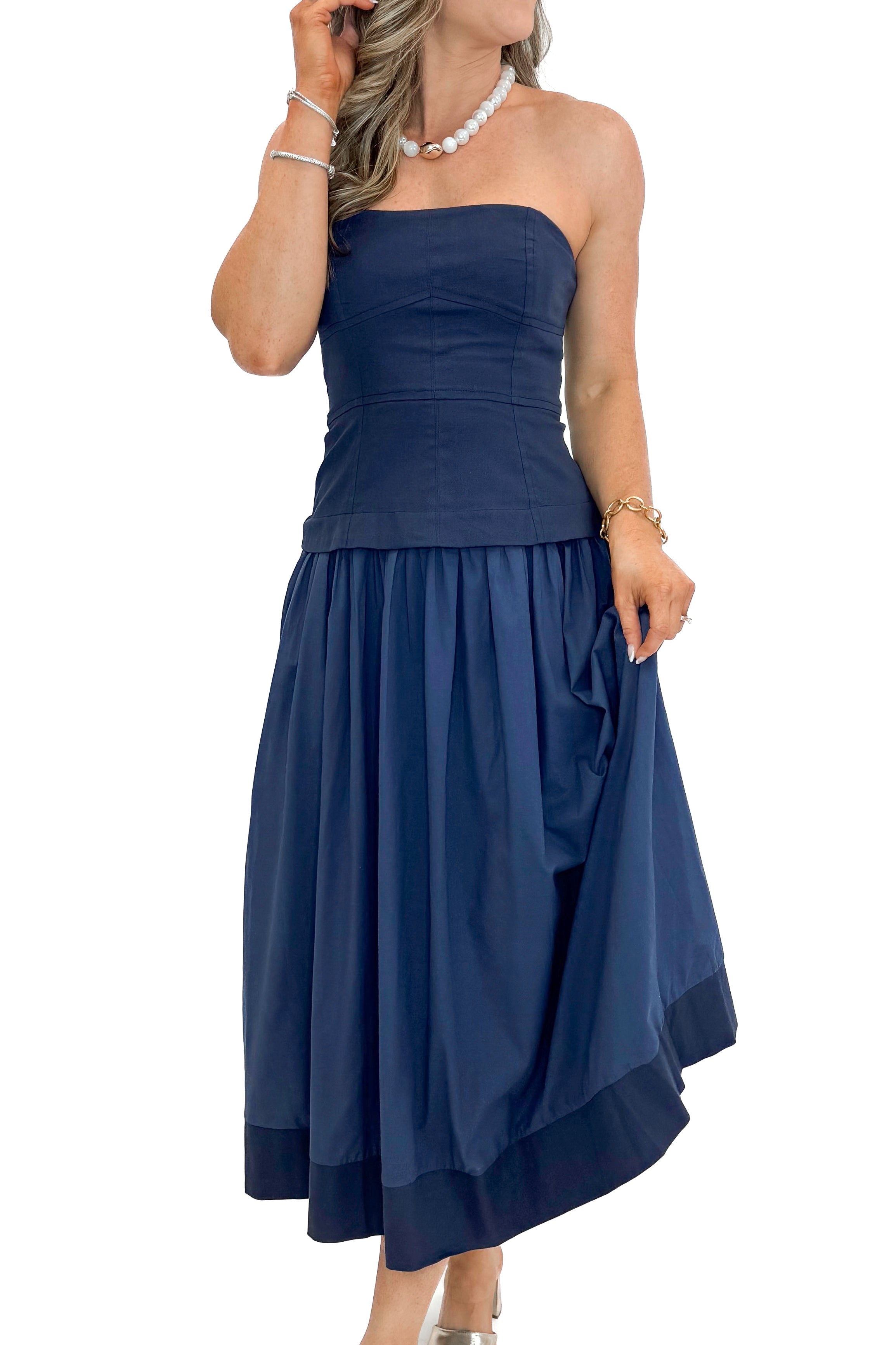 Front view of woman wearing Navy Corset Lined Midi Dress against white studio background.