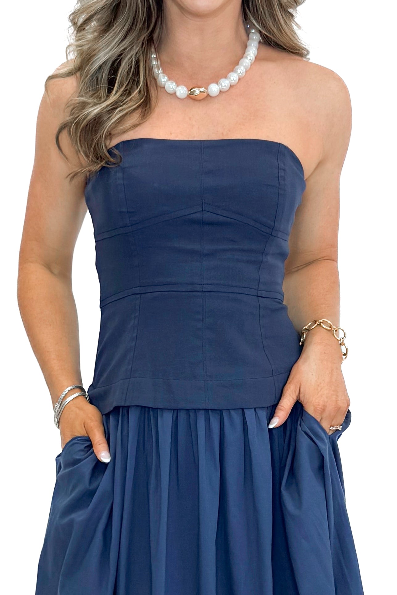 Front detail view of woman wearing Navy Corset Lined Midi Dress against white studio background.