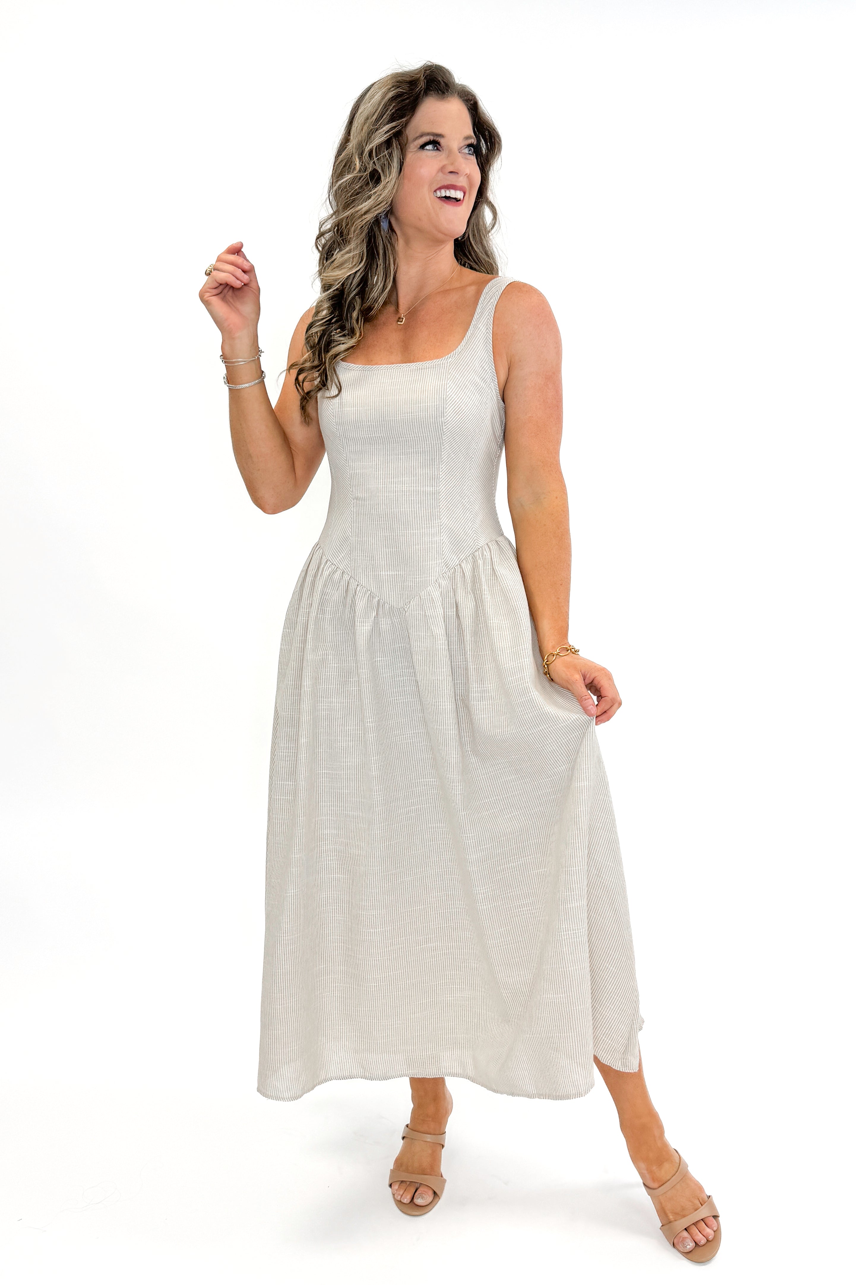 Front view of woman wearing Taupe Striped V-Waist Dress against white studio background.