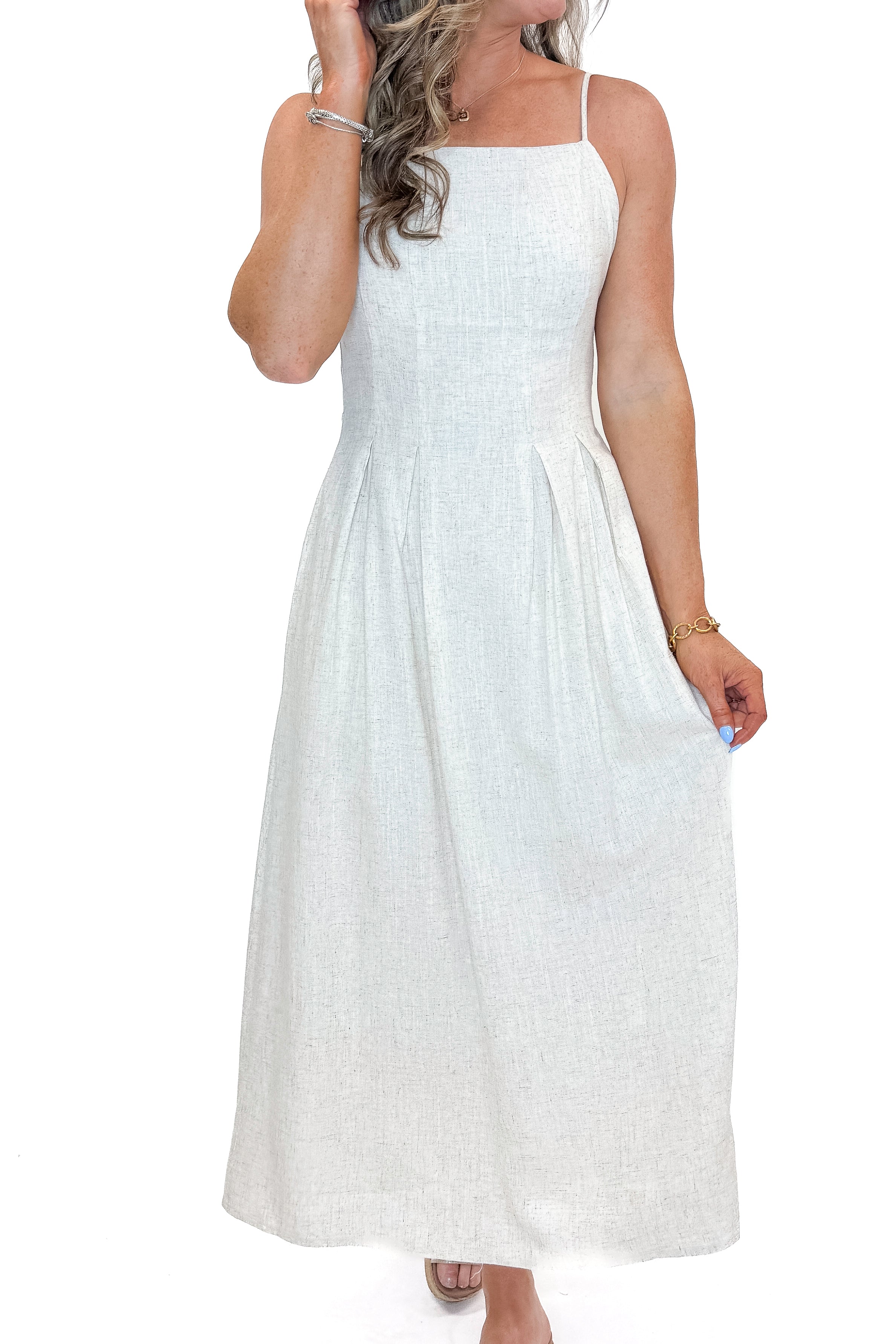 Front detail view of woman wearing Linen Pleat Detail Tank Dress with sandals against white studio background.
