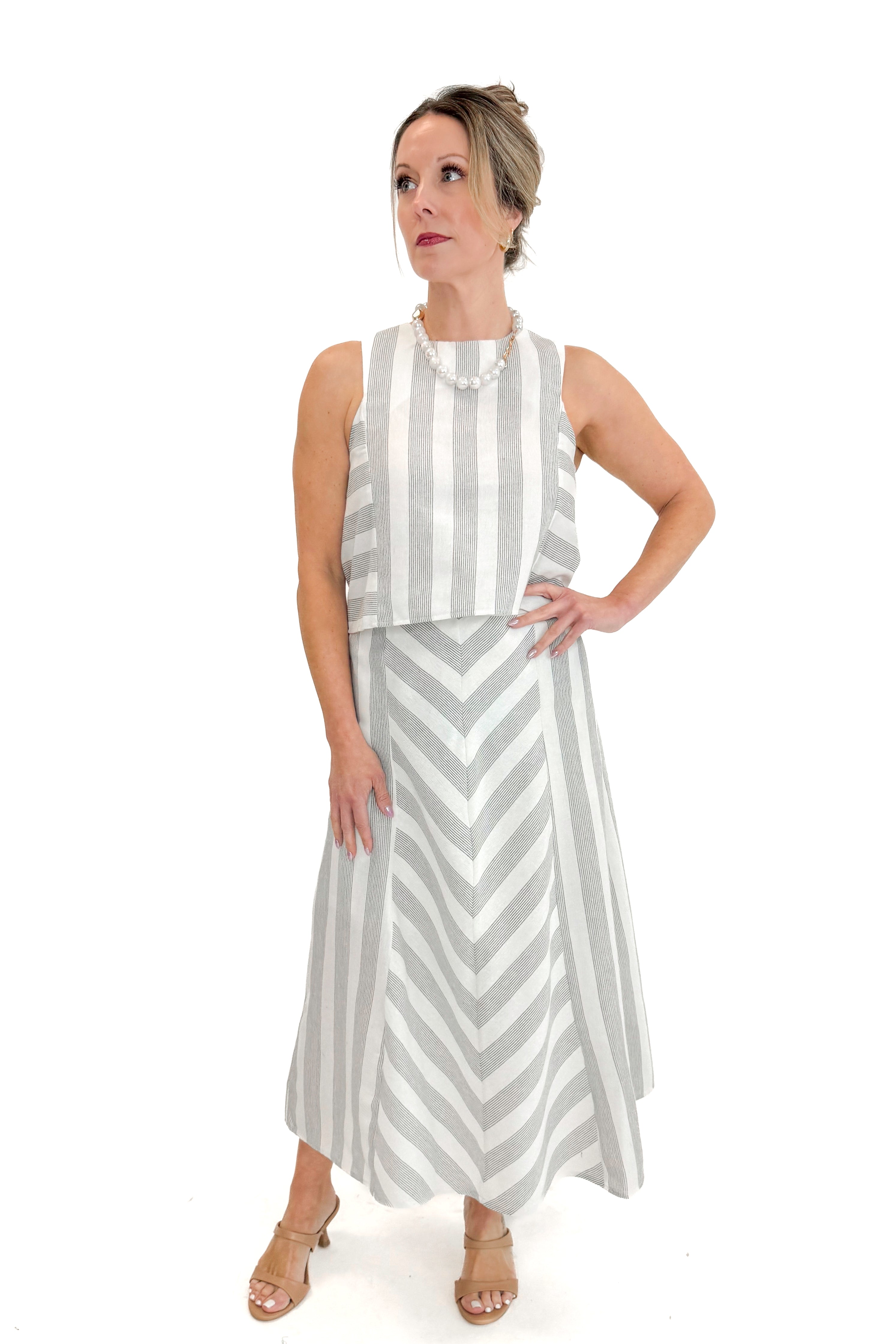 Front view of woman wearing Cream & Grey Striped Skirt by Entro with matching tank against white studio background.