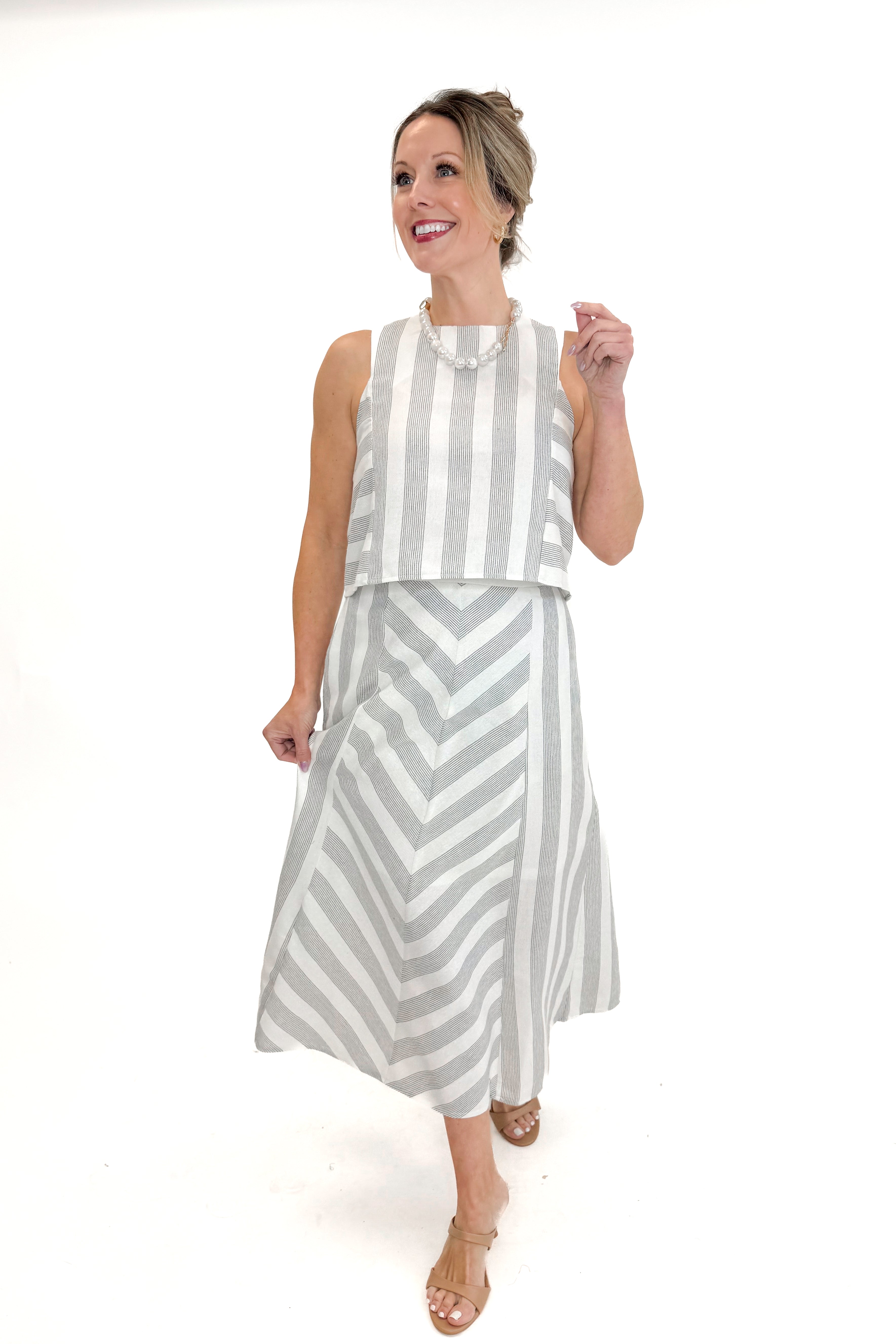 Front view of woman wearing Cream & Grey Striped Skirt by Entro with matching tank against white studio background.
