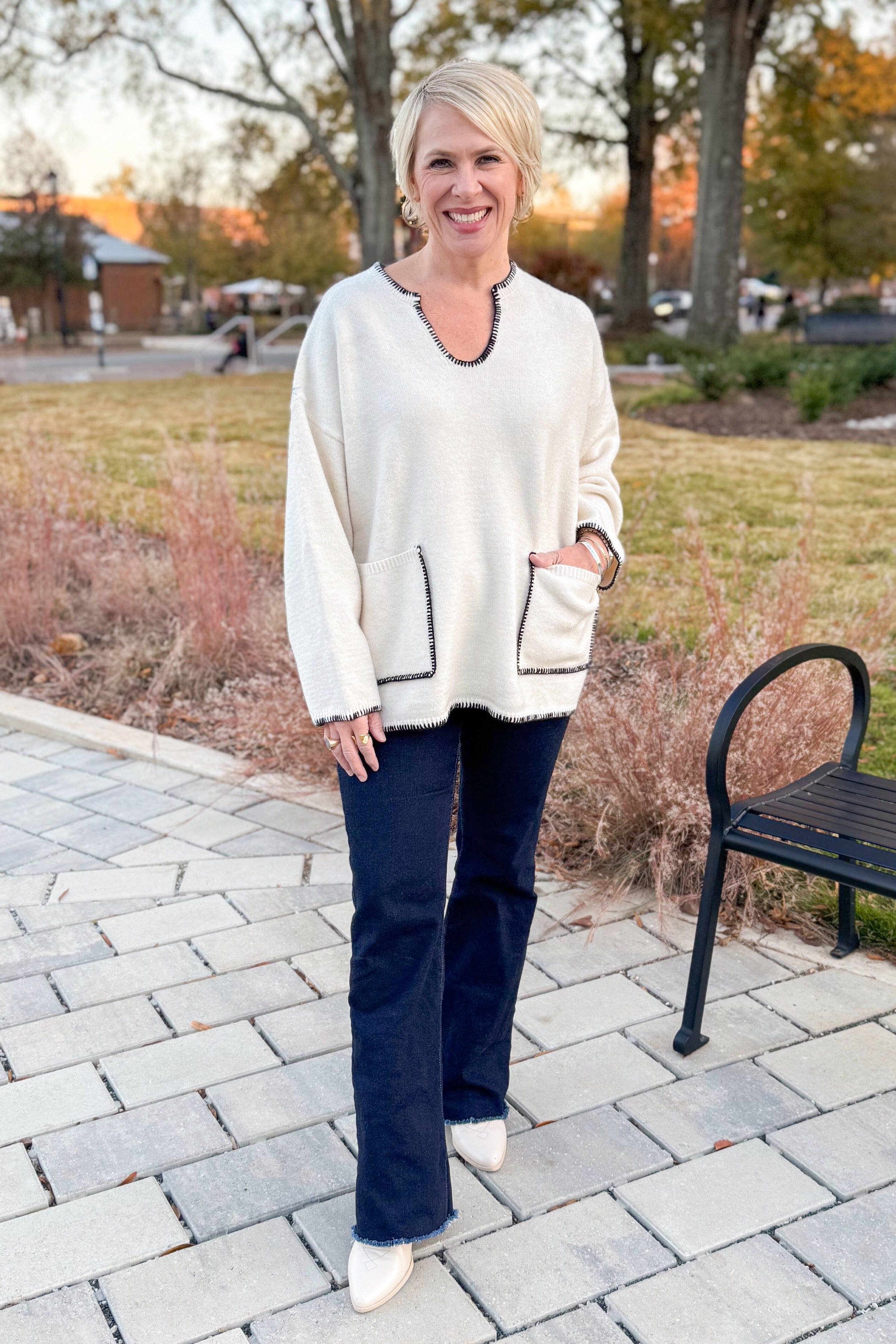 Front view of woman wearing Cream Pocket & Stitch Detail Sweater with jeans outside.
