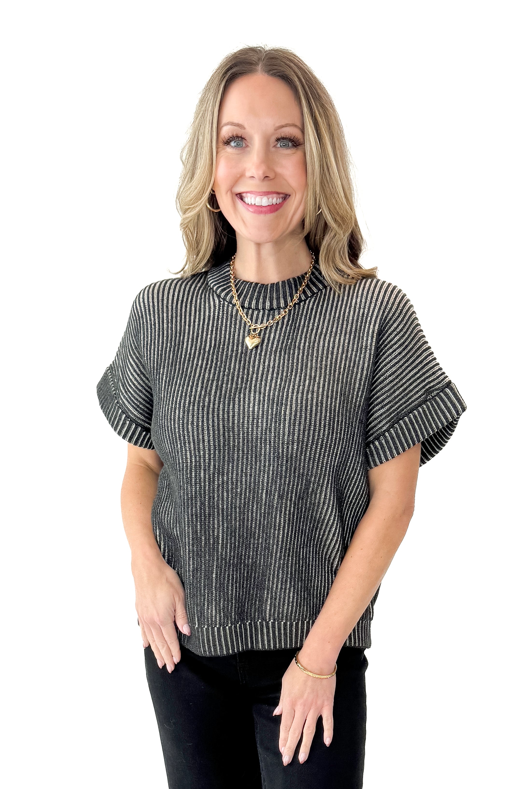 Front view of woman wearing Black & White Ribbed Short Sleeve Sweater with jeans against white studio background.