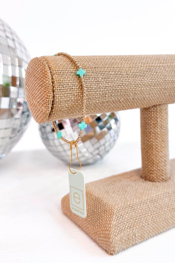 Bracelet with mint beads on a beaded stand with a tag