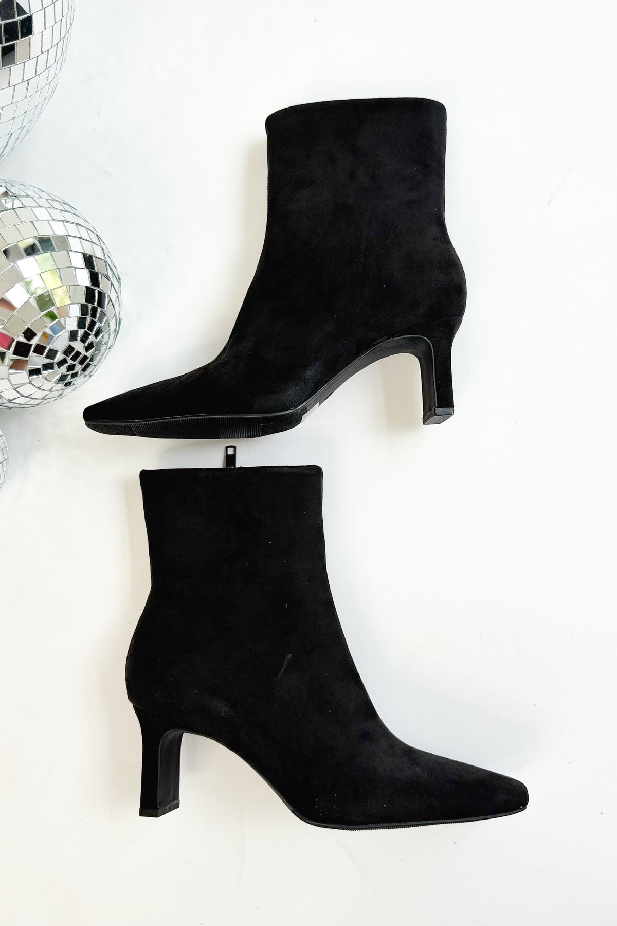 Swan- Black Suede Booties side view against white studio background.