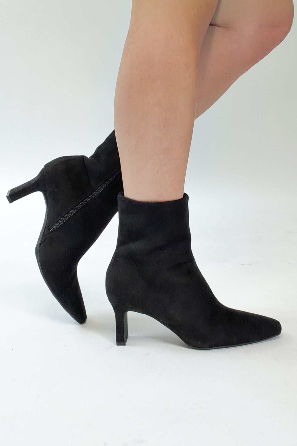 Swan- Black Suede Booties side view against white studio background.