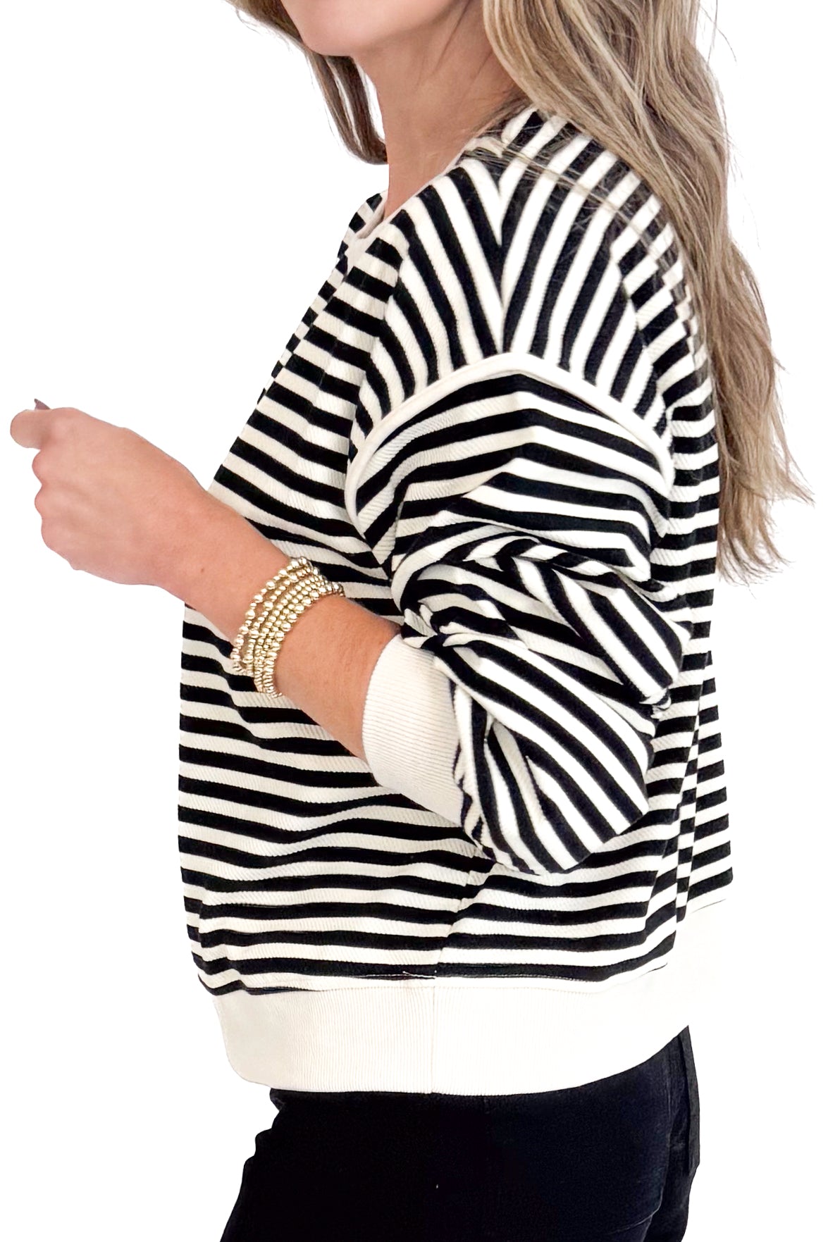 Black and white striped sweater worn by a person on a white background