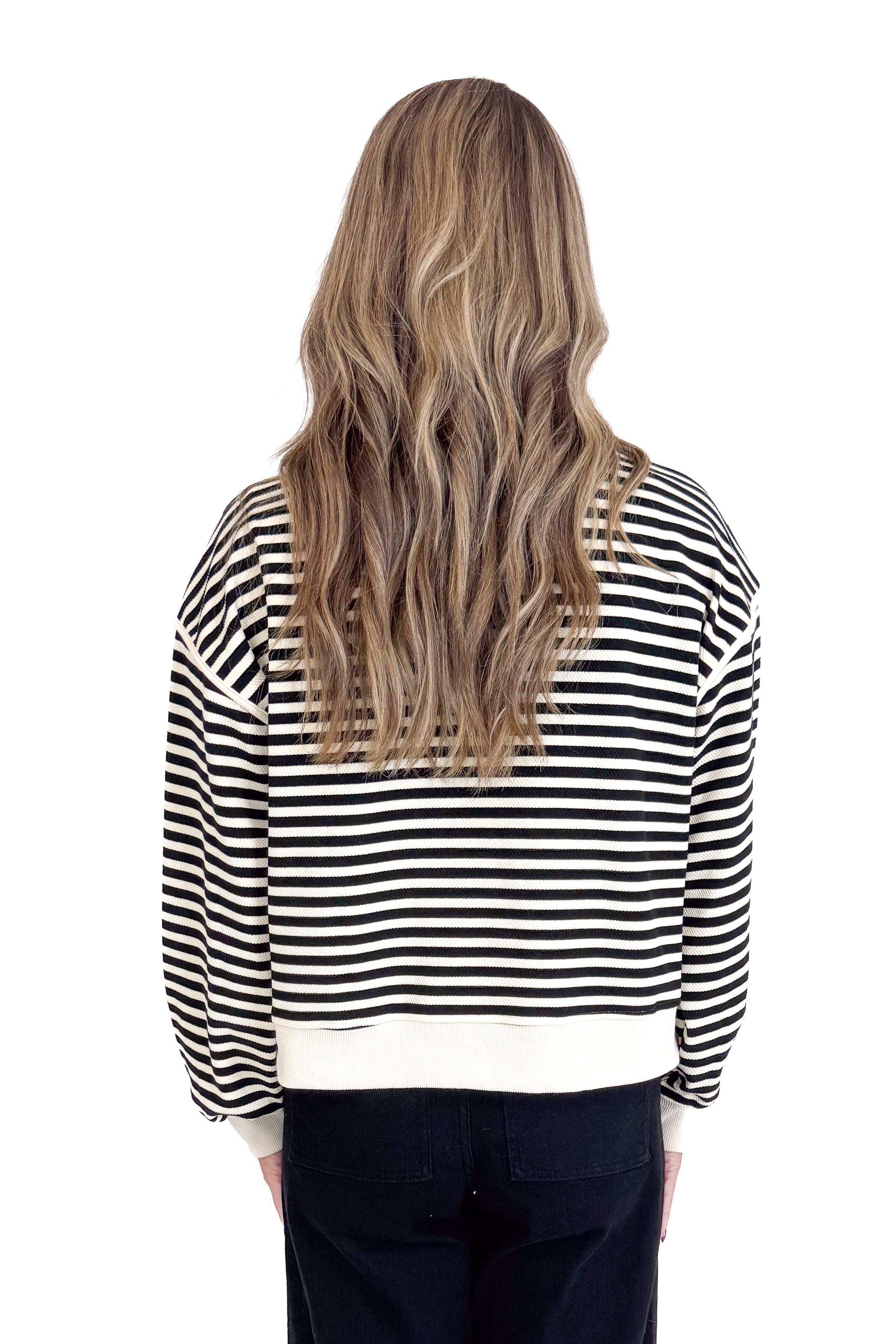 Person wearing a black and white striped shirt on a white background