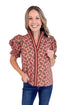Woman wearing a patterned blouse on a white background