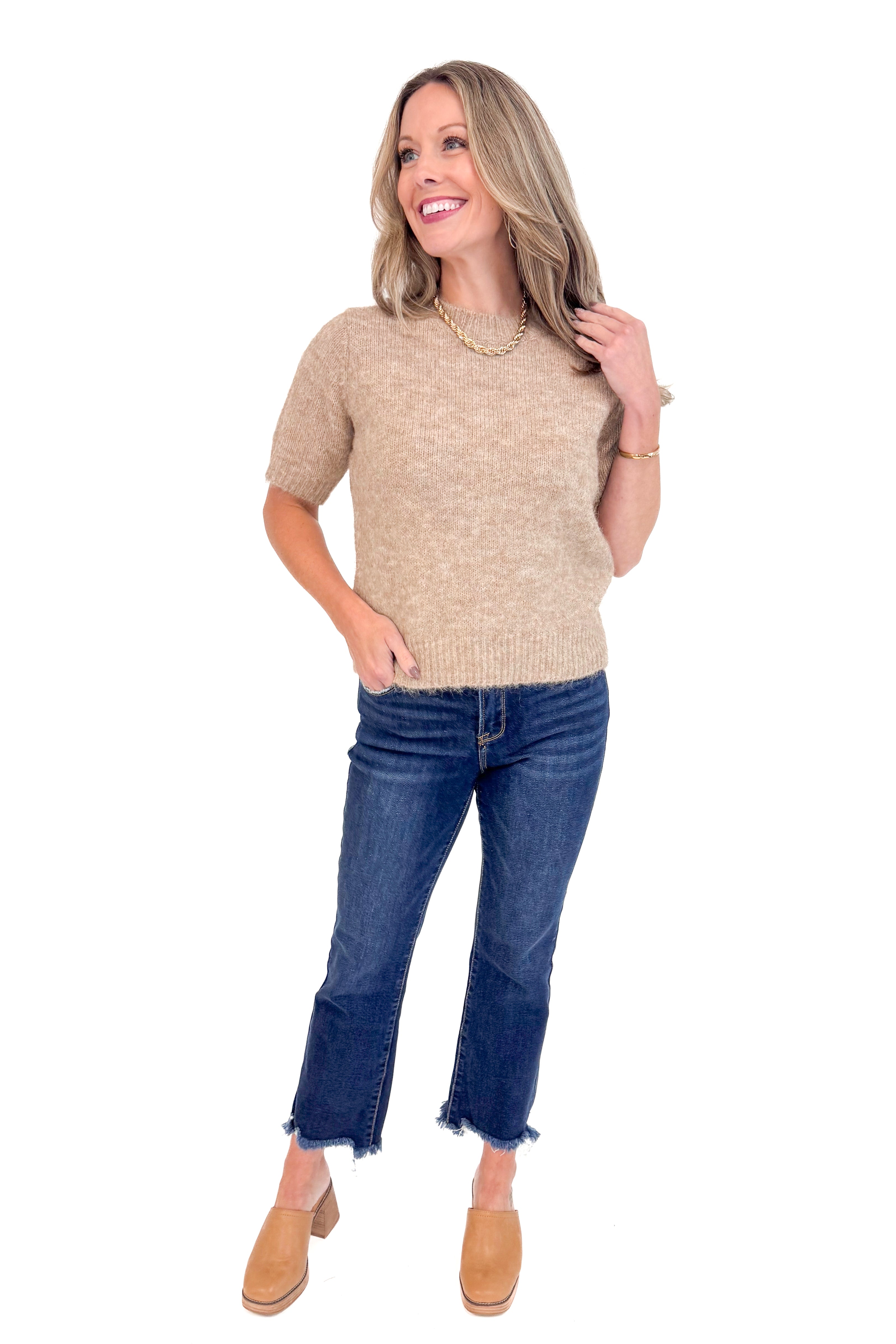 Woman wearing Mocha Short Sleeve Fuzzy Sweater by Entro and blue jeans with white studio background.