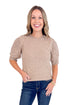 Woman wearing a beige sweater with lace sleeves on a white background