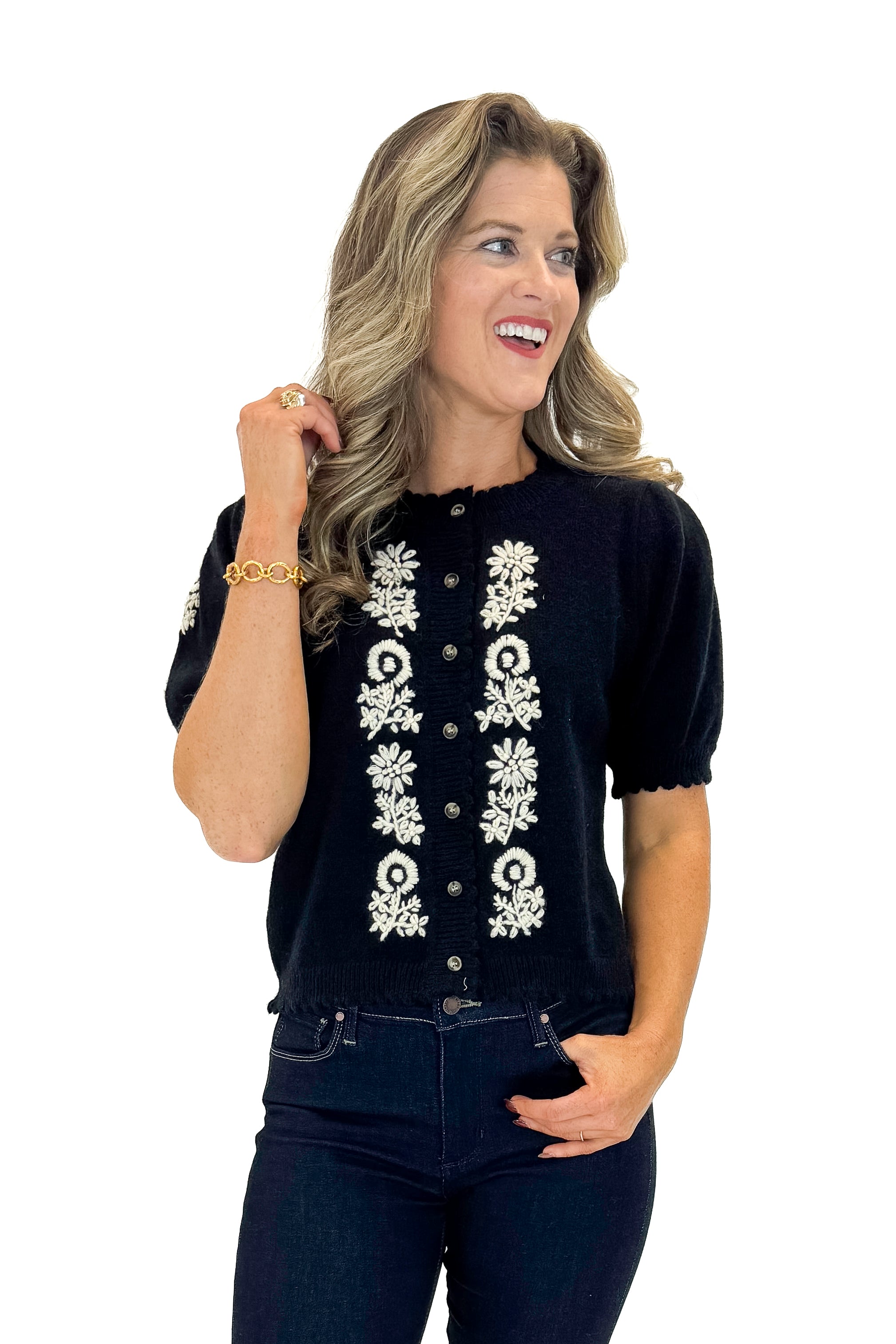 Front view of woman wearing Black Center Embroidered Short Sleeve Cardigan with jeans against white studio background.