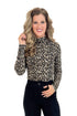 Front view of woman wearing leopard print mock neck top showing ribbed texture and animal print design.