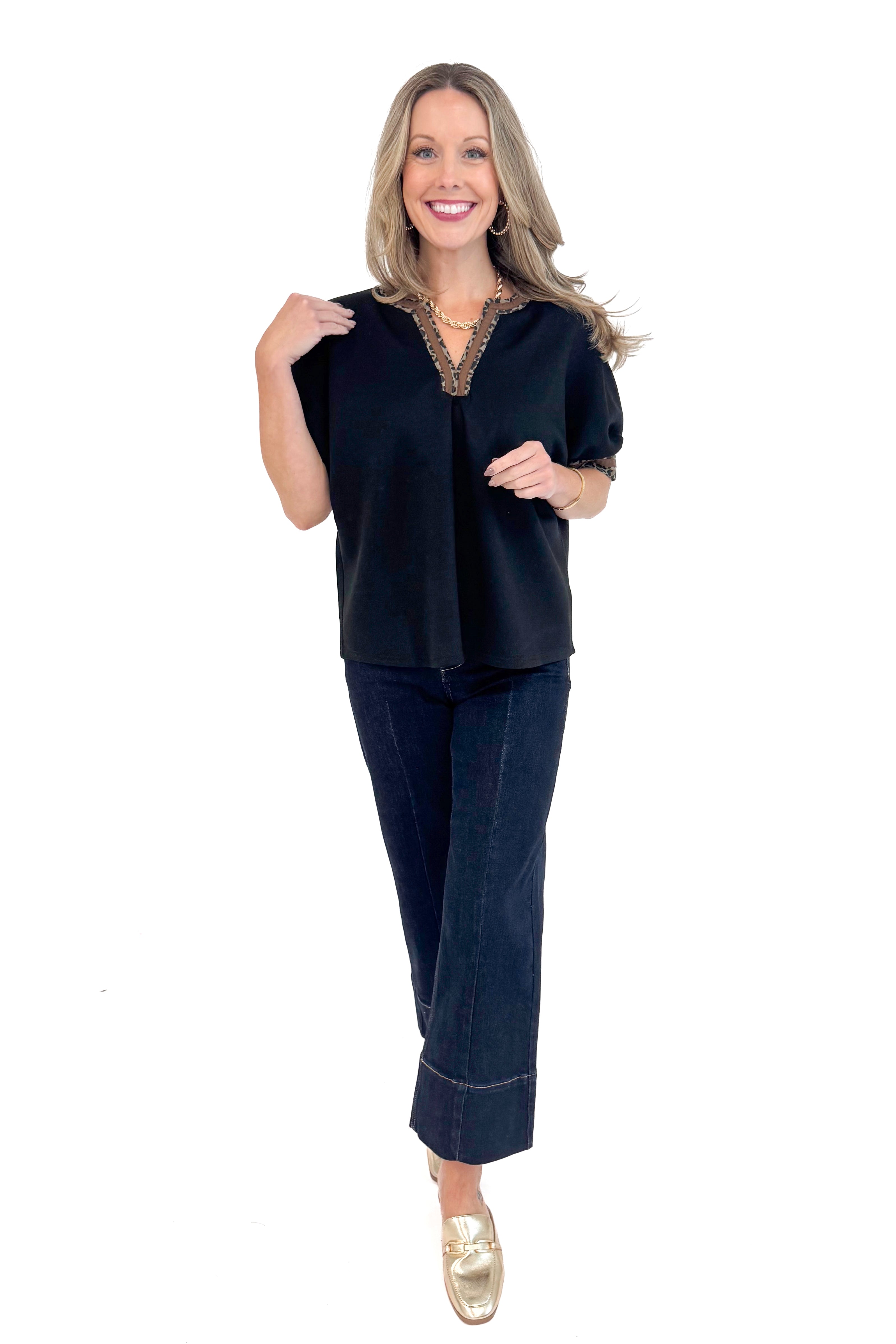 Front full length photo of woman wearing a Black Leopard Lined V-neck Top by Entro.