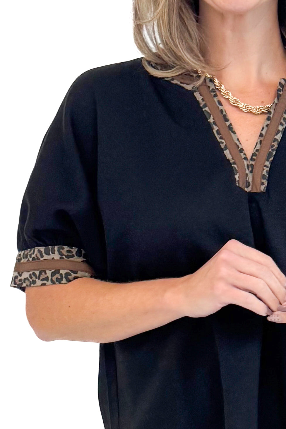 Front detailed view photo of woman wearing a Black Leopard Lined V-neck Top by Entro.