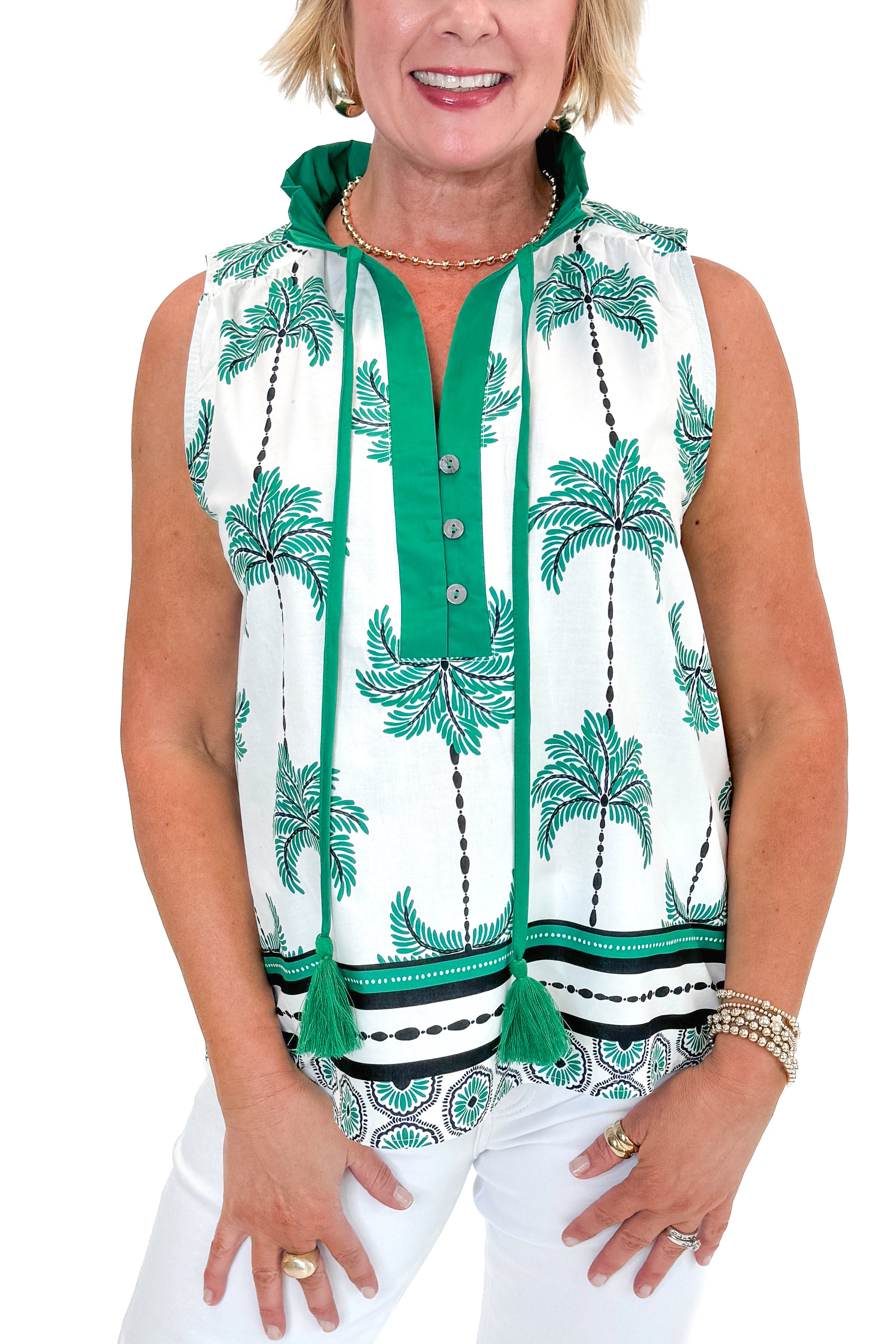 Front detail view of woman wearing Green Palm Printed Sleeveless Top by Entro with jeans against white studio background.