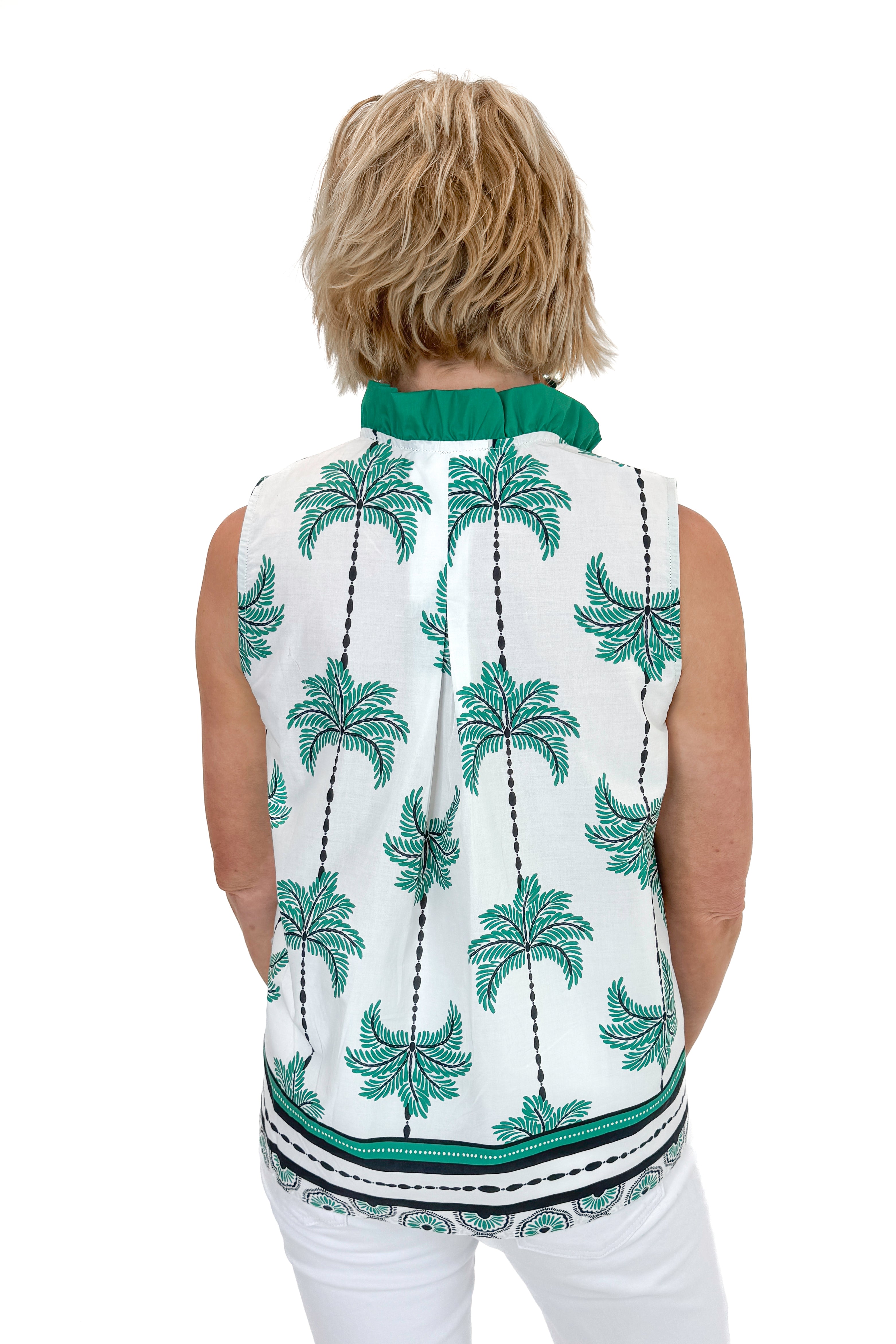 Back view of woman wearing Green Palm Printed Sleeveless Top by Entro with jeans against white studio background.