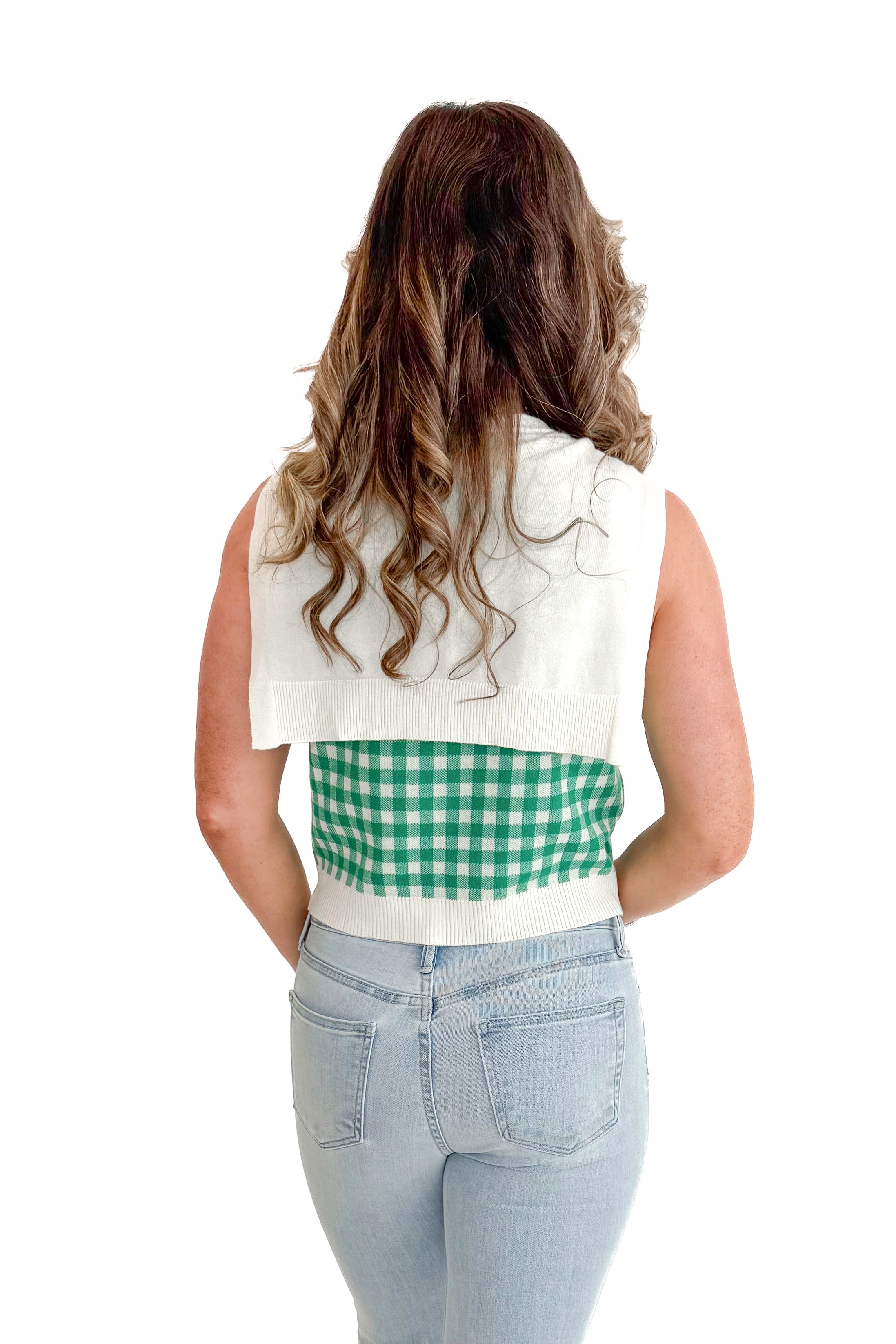 Back view of woman wearing Green Plaid Faux Layered Sweater Tank by Entro with jeans against white studio background.