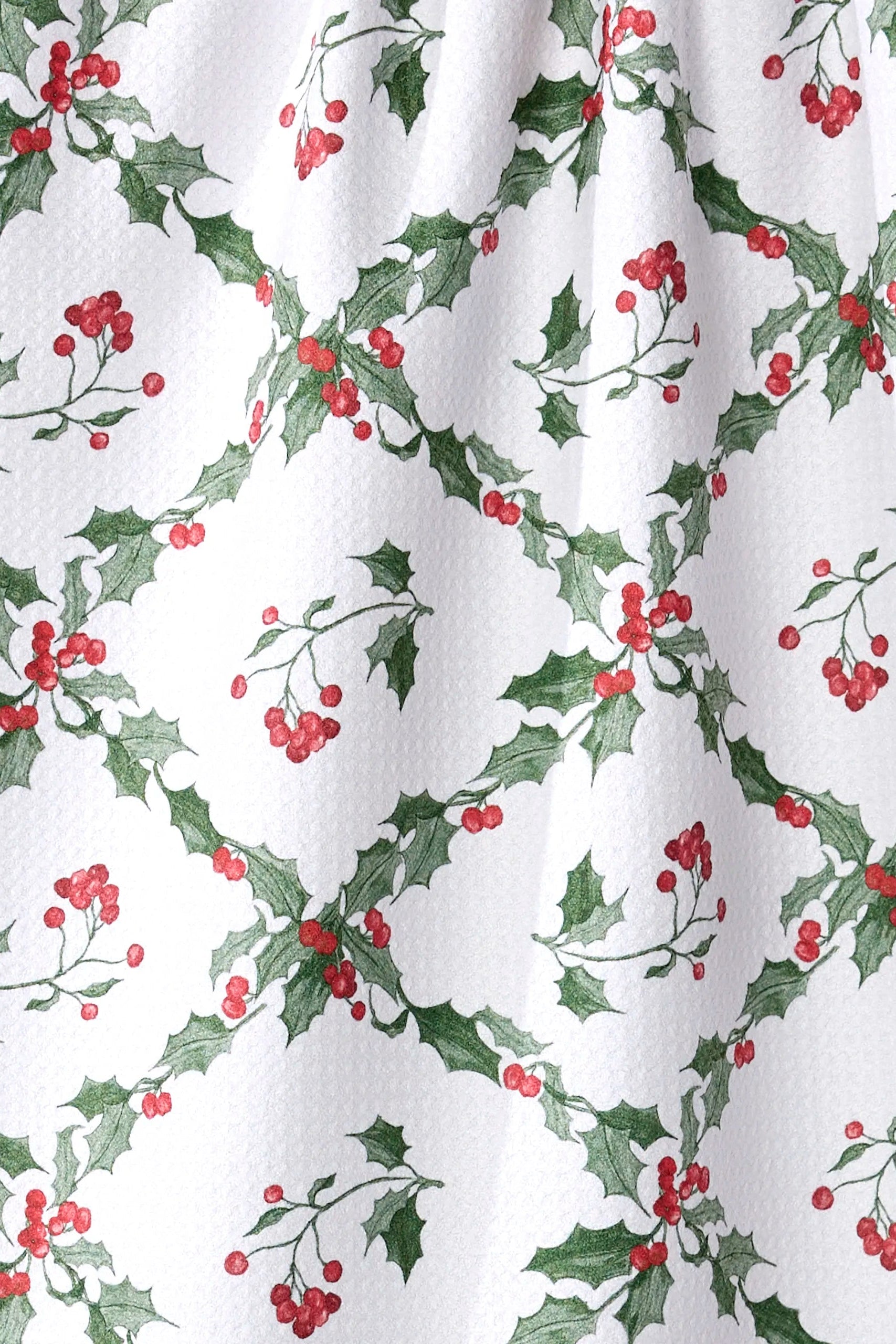 Curtain with holly leaf and berry pattern on a white background