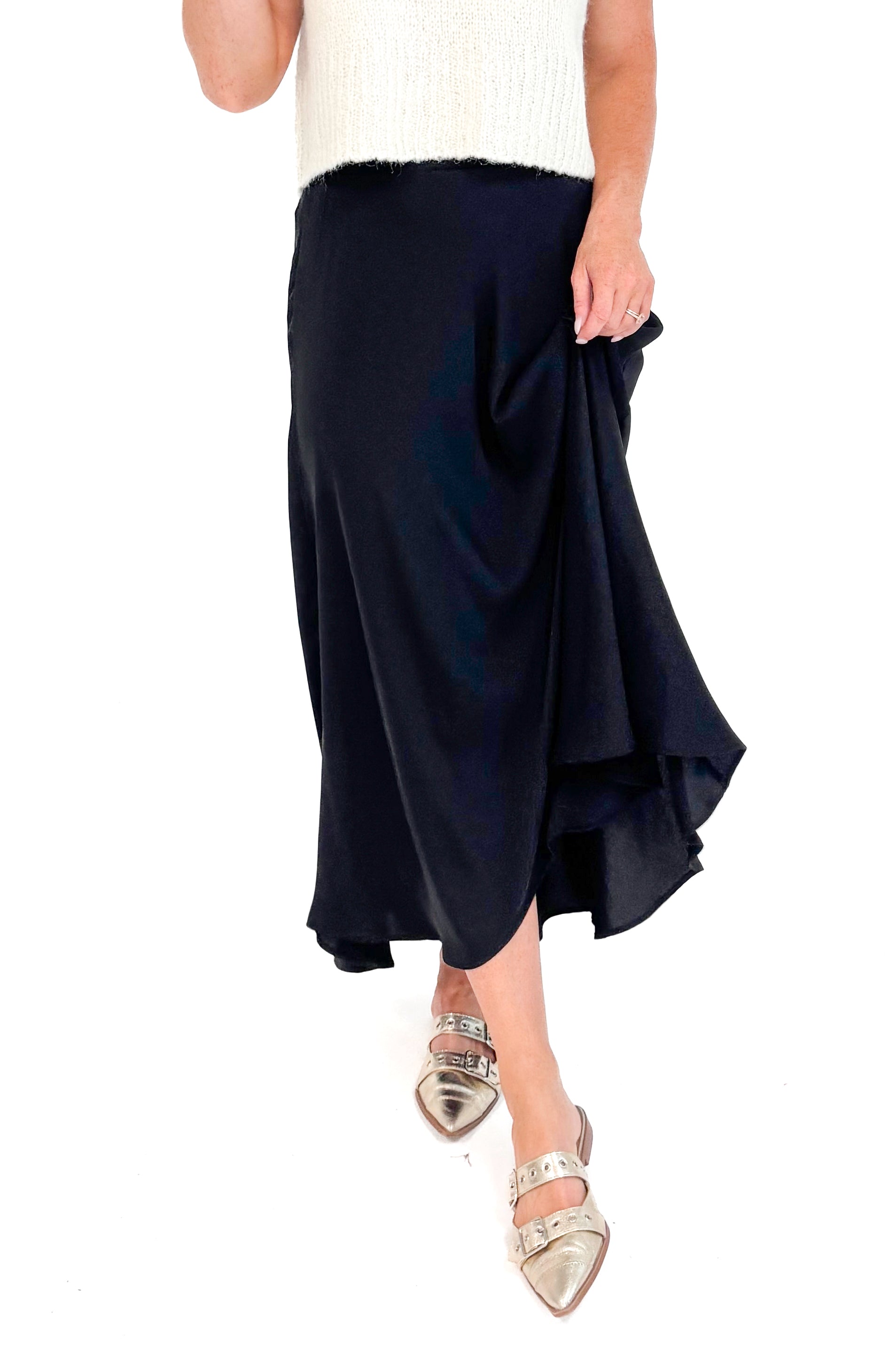 Front view close up of black satin swing skirt showing pleated detail and movement.