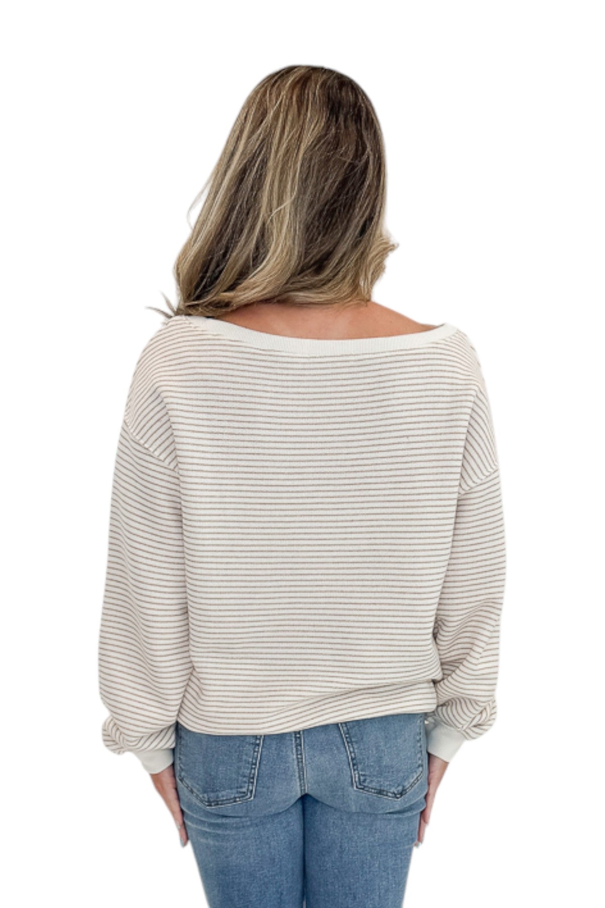 Back view of woman wearing Swagger Boutiqueās Taupe & Cream Striped Off The Shoulder Sweatshirt with jeans against white studio background.