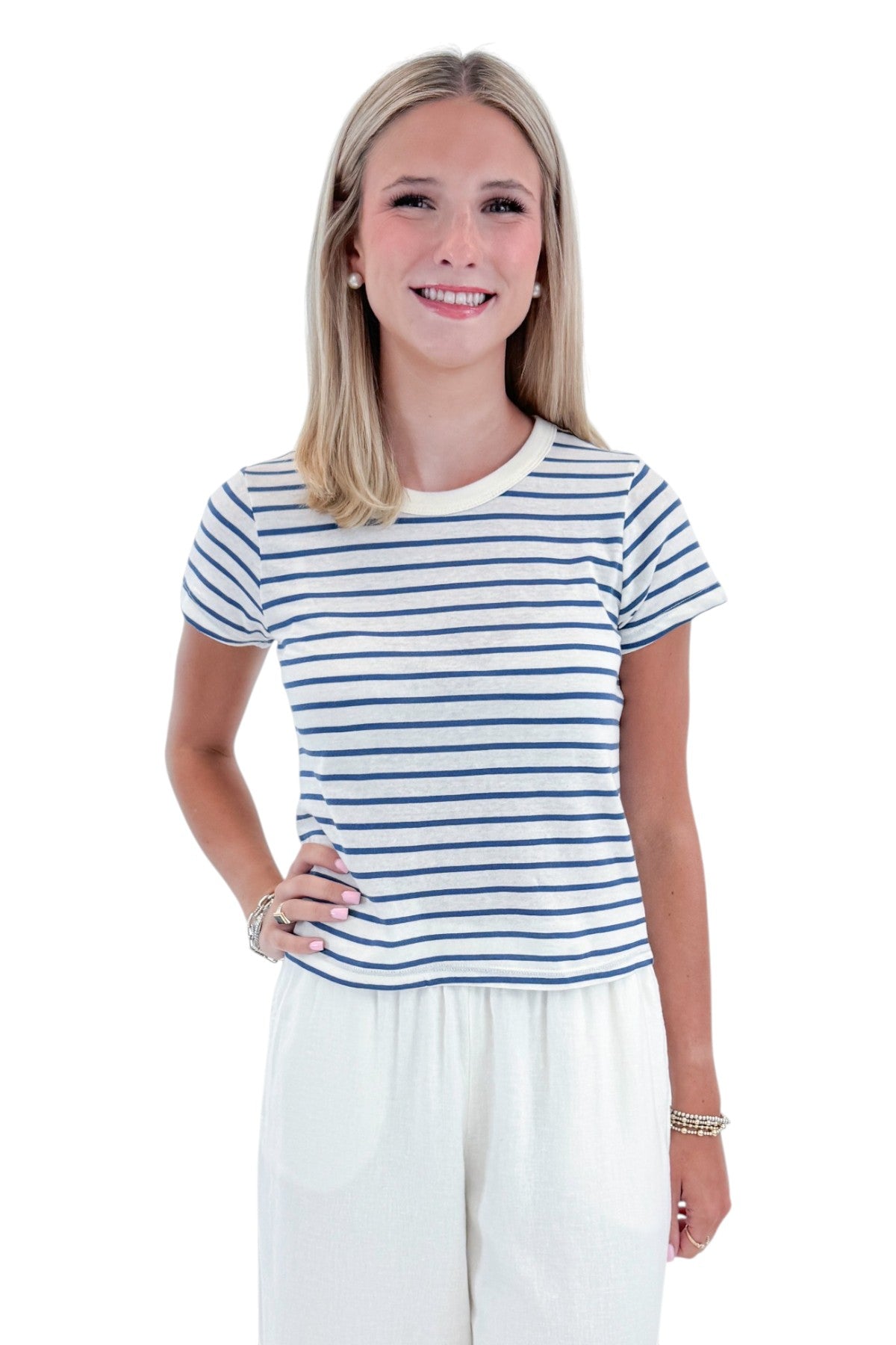 Front view of woman wearing Swagger Boutique’s True Navy Junie Striped Tee by Z Supply with White Scout Linen Pants by Z Supply against white studio background.