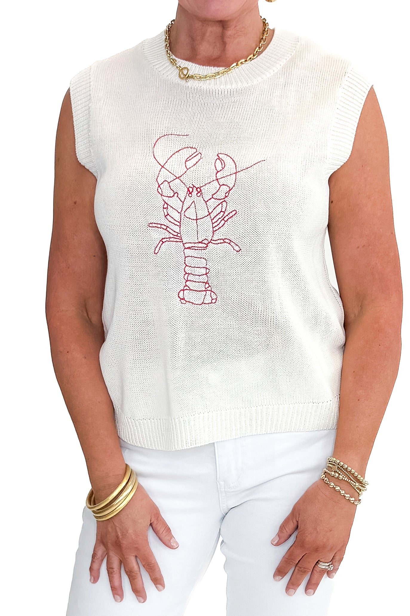 Front detailed view of woman wearing Cream Lobster Embroidered Sleeveless Sweater with jeans against white studio background.