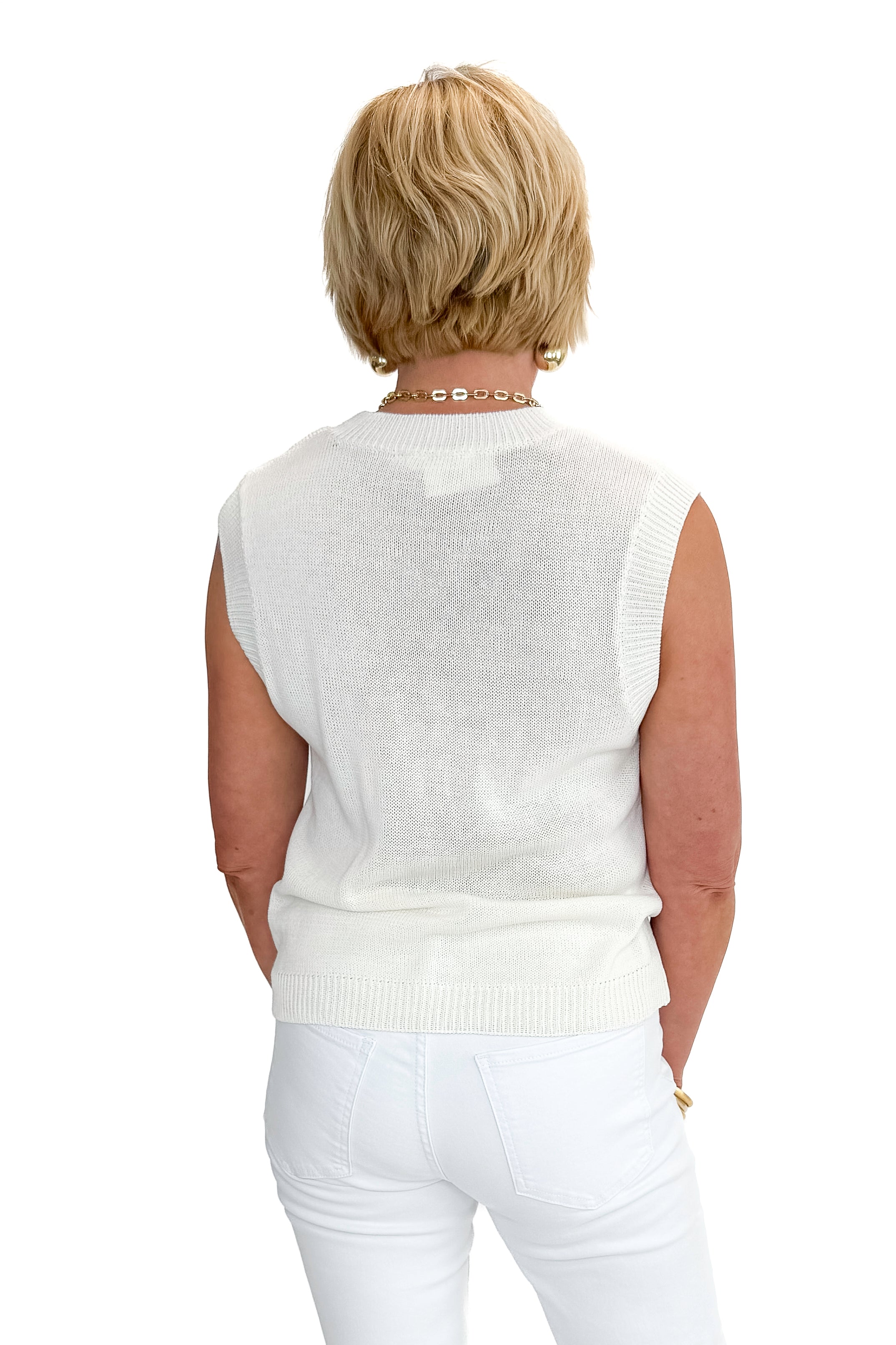 Back view of woman wearing Cream Lobster Embroidered Sleeveless Sweater with jeans against white studio background.