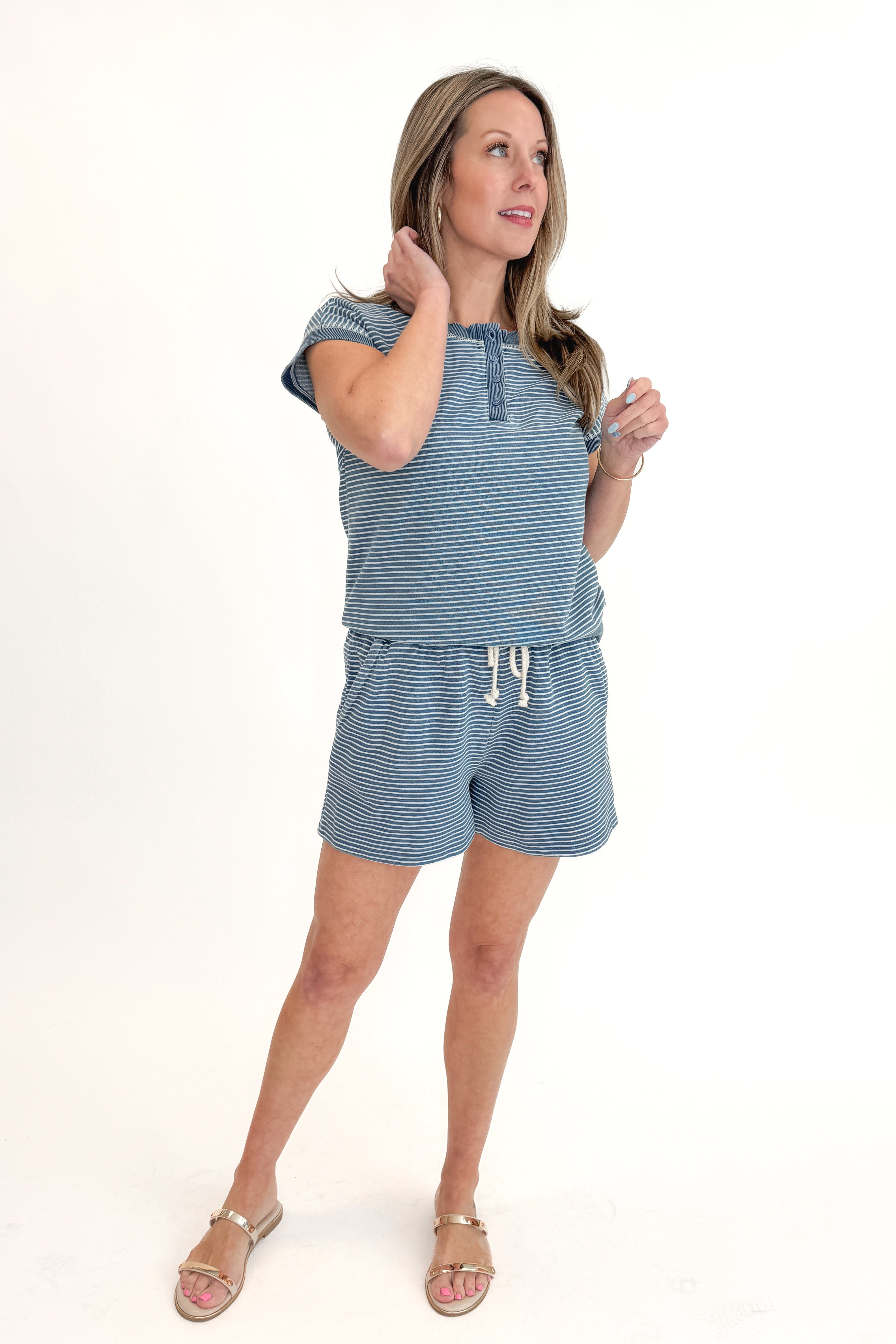 Front view of woman wearing Washed Blue Striped Drawstring Shorts with matching top against white studio background.