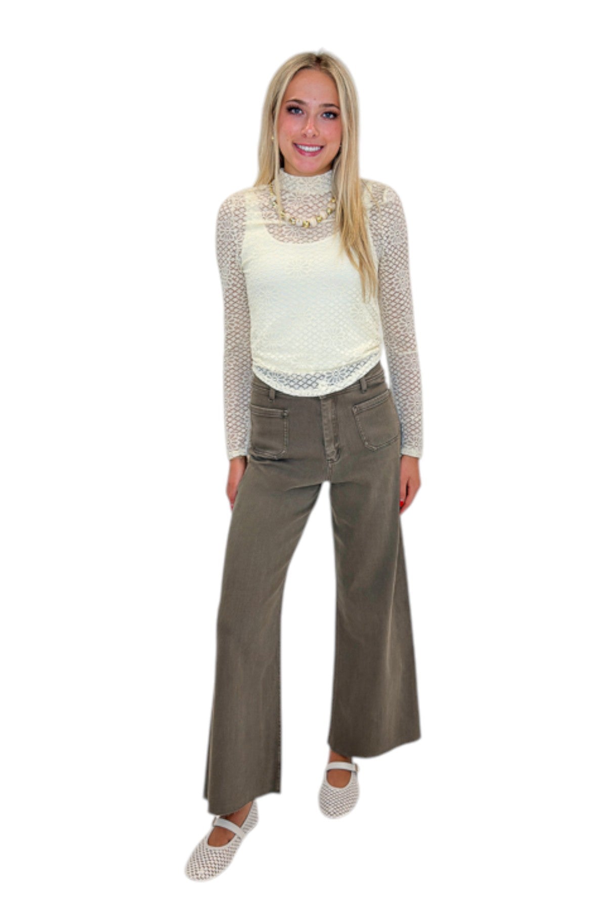 Front view of woman wearing Swagger Boutique’s Washed Brown Patch Pocket Wide Leg Jeans with top against white studio background.