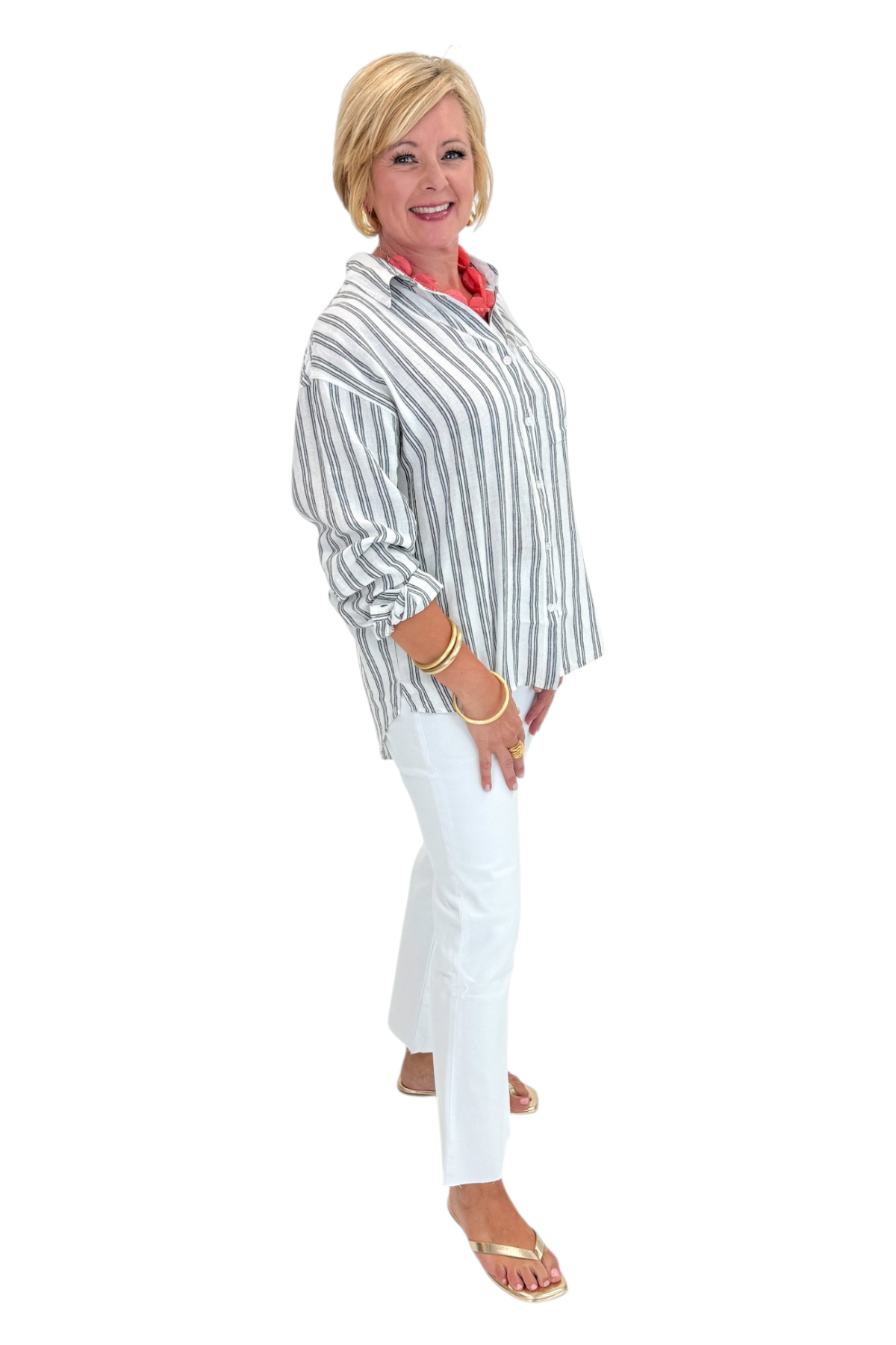 Side view of woman wearing Swagger Boutique’s White The Perfect Striped Button Up Top by Z Supply with jeans against white studio background.