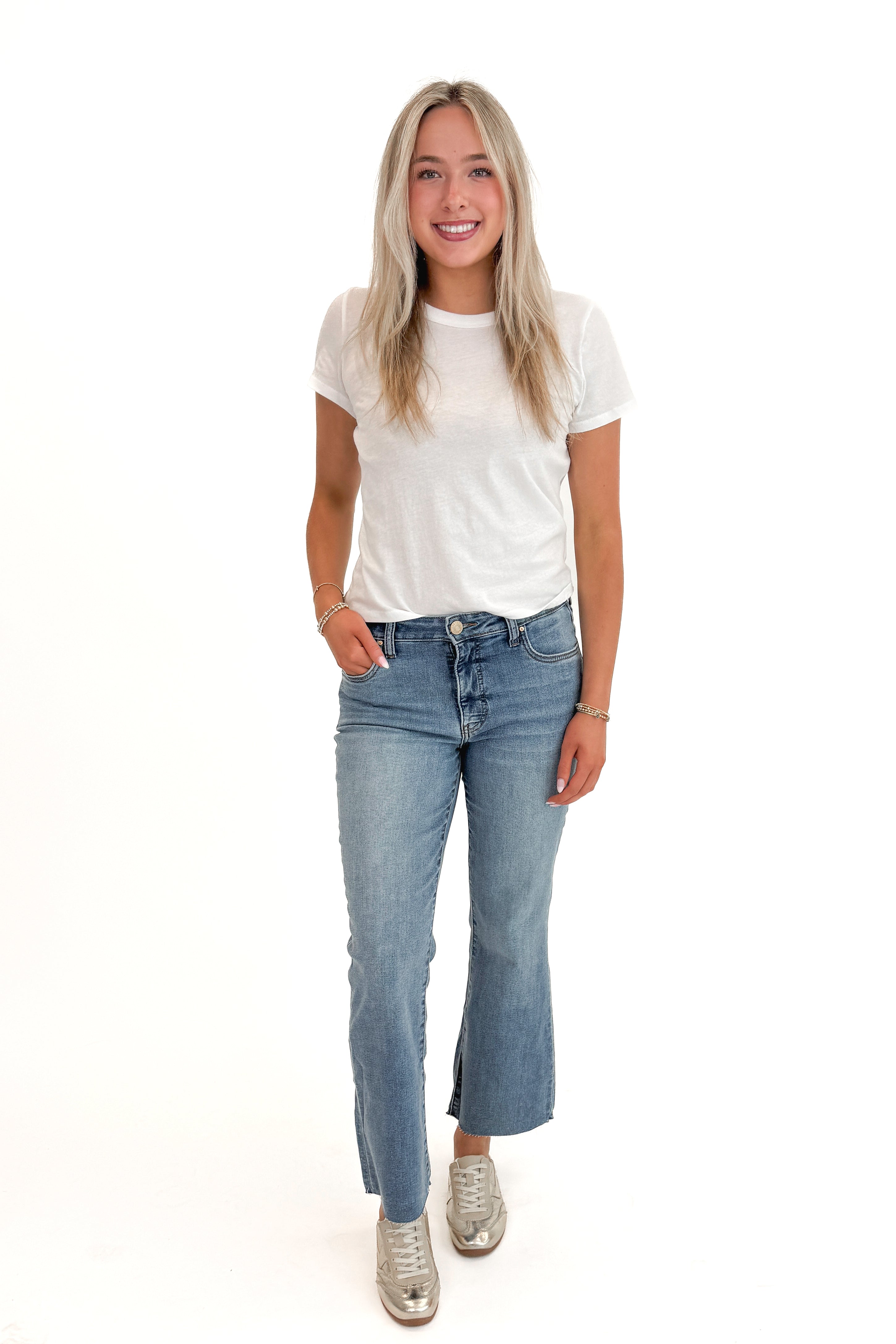 Front view of woman wearing Swagger Boutique’s White Tourist Tee by Z Supply with jeans against white studio background.