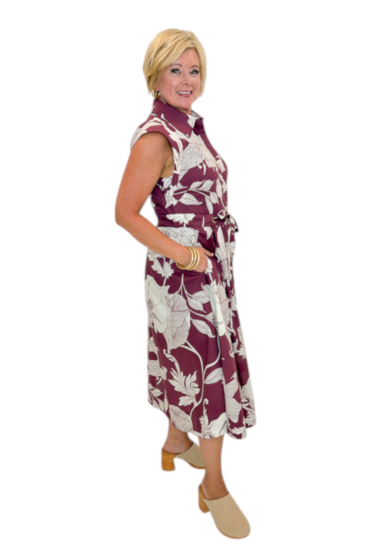 Side view of woman wearing Swagger Boutiqueās Wine Floral Tie Waist Midi Dress by Entro against white studio background.