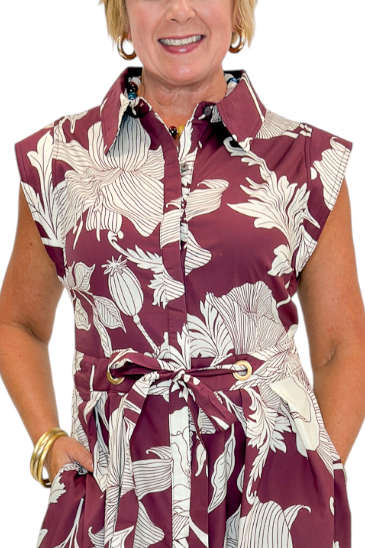 Front detail view of woman wearing Swagger Boutiqueās Wine Floral Tie Waist Midi Dress by Entro against white studio background.