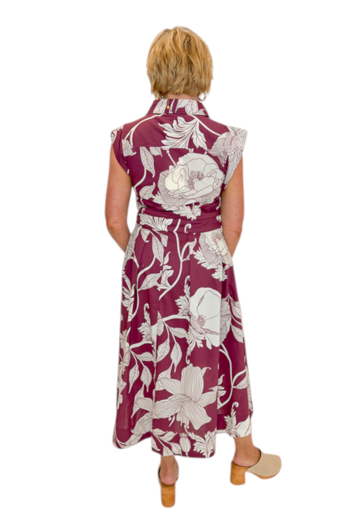 Back view of woman wearing Swagger Boutiqueās Wine Floral Tie Waist Midi Dress by Entro against white studio background.