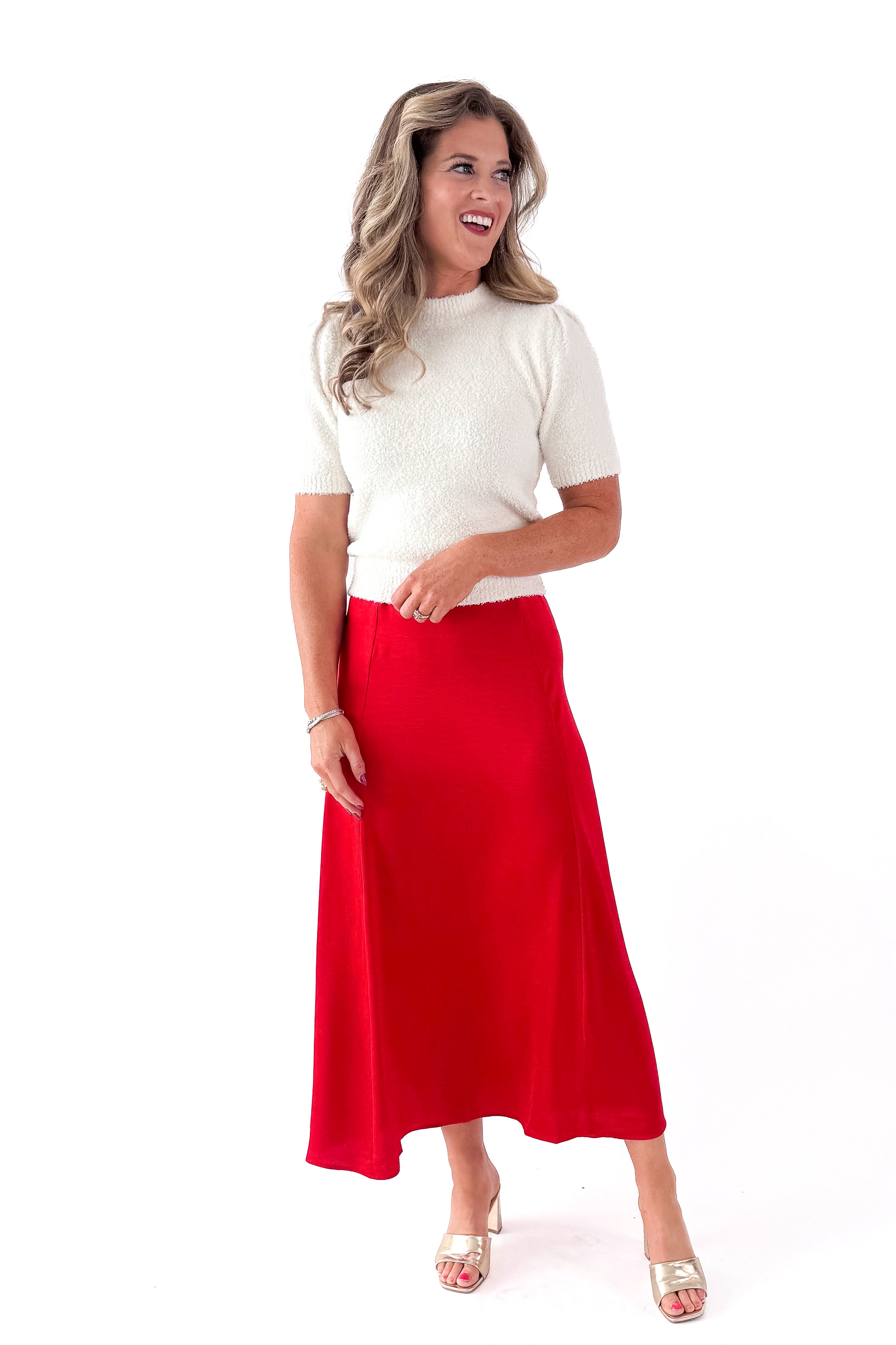 Front view of woman wearing cream top with Festive Red Northpointe Midi Skirt against white studio background.