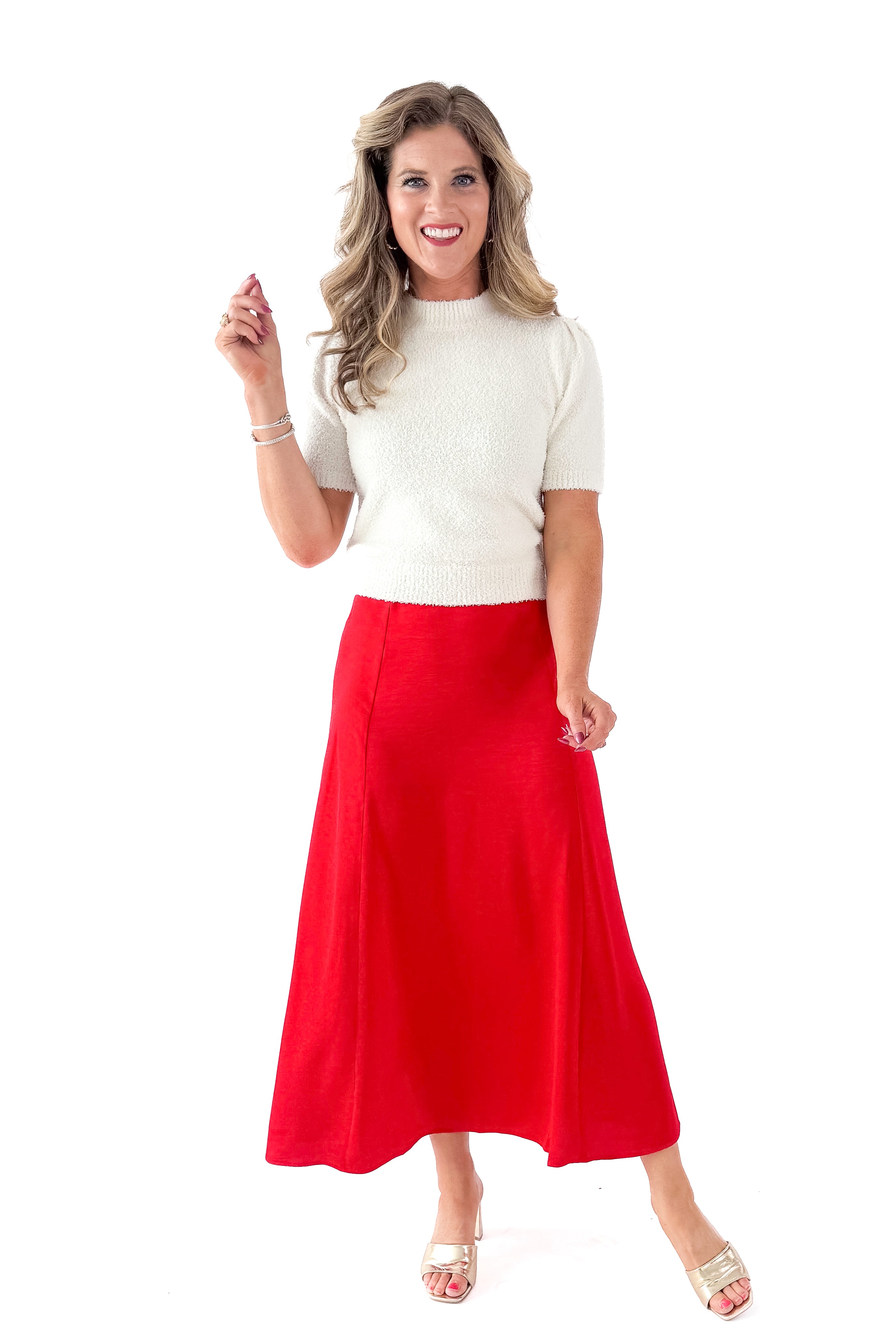 Front view of woman wearing cream top with Festive Red Northpointe Midi Skirt against white studio background.