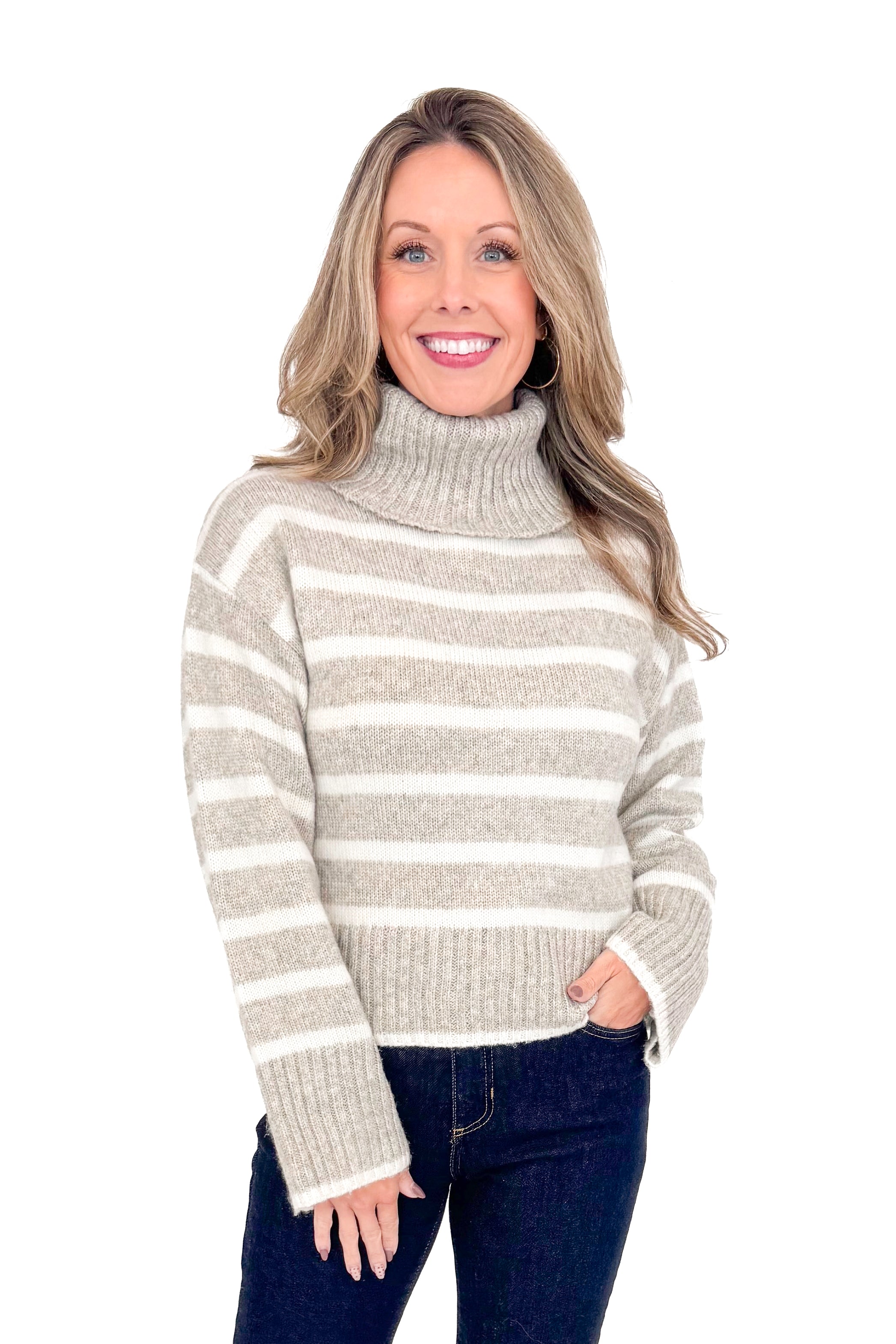 Front view of woman wearing Z Supply stripe Josephine sweater with jeans against white studio background.