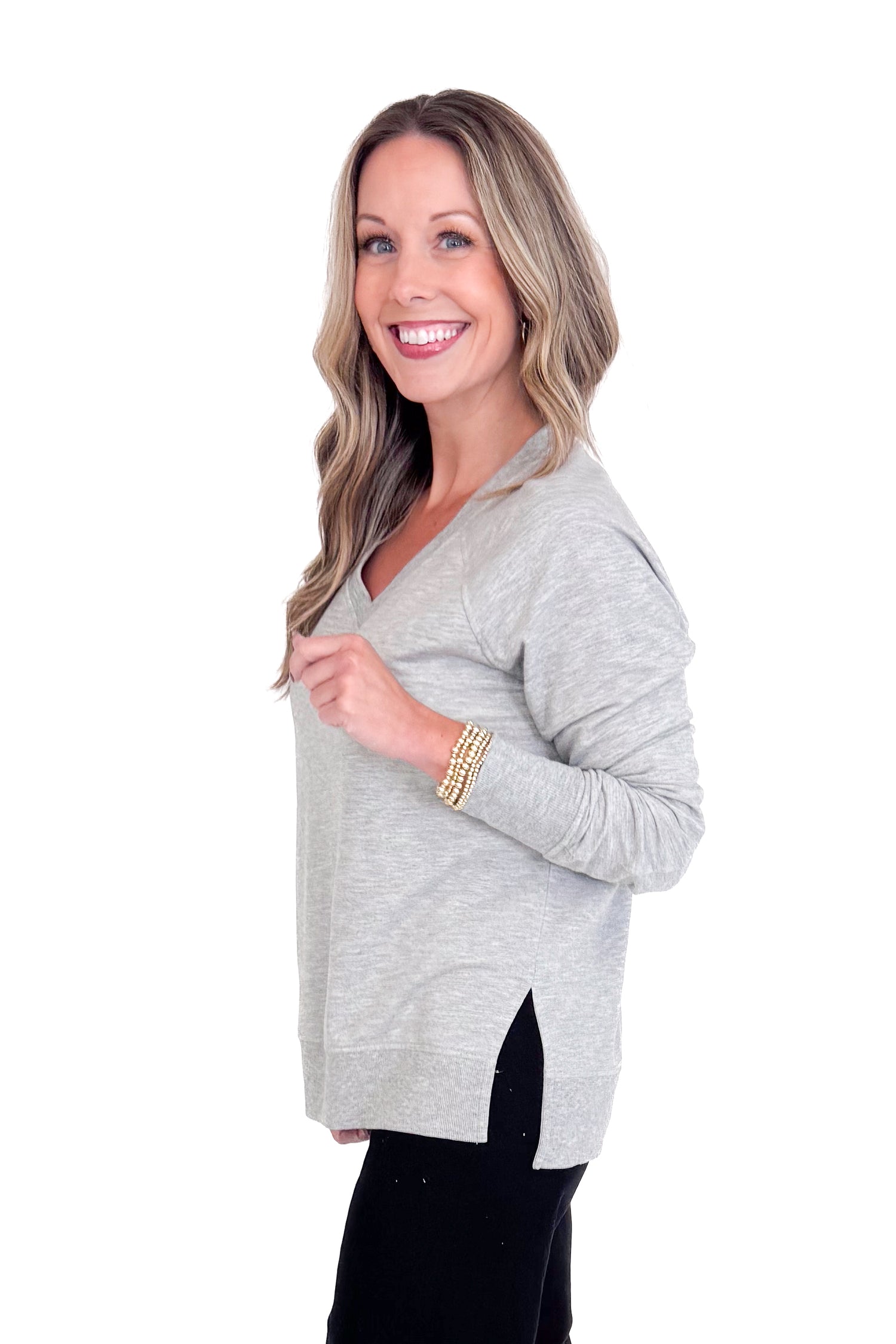 Woman wearing a gray cardigan on a white background
