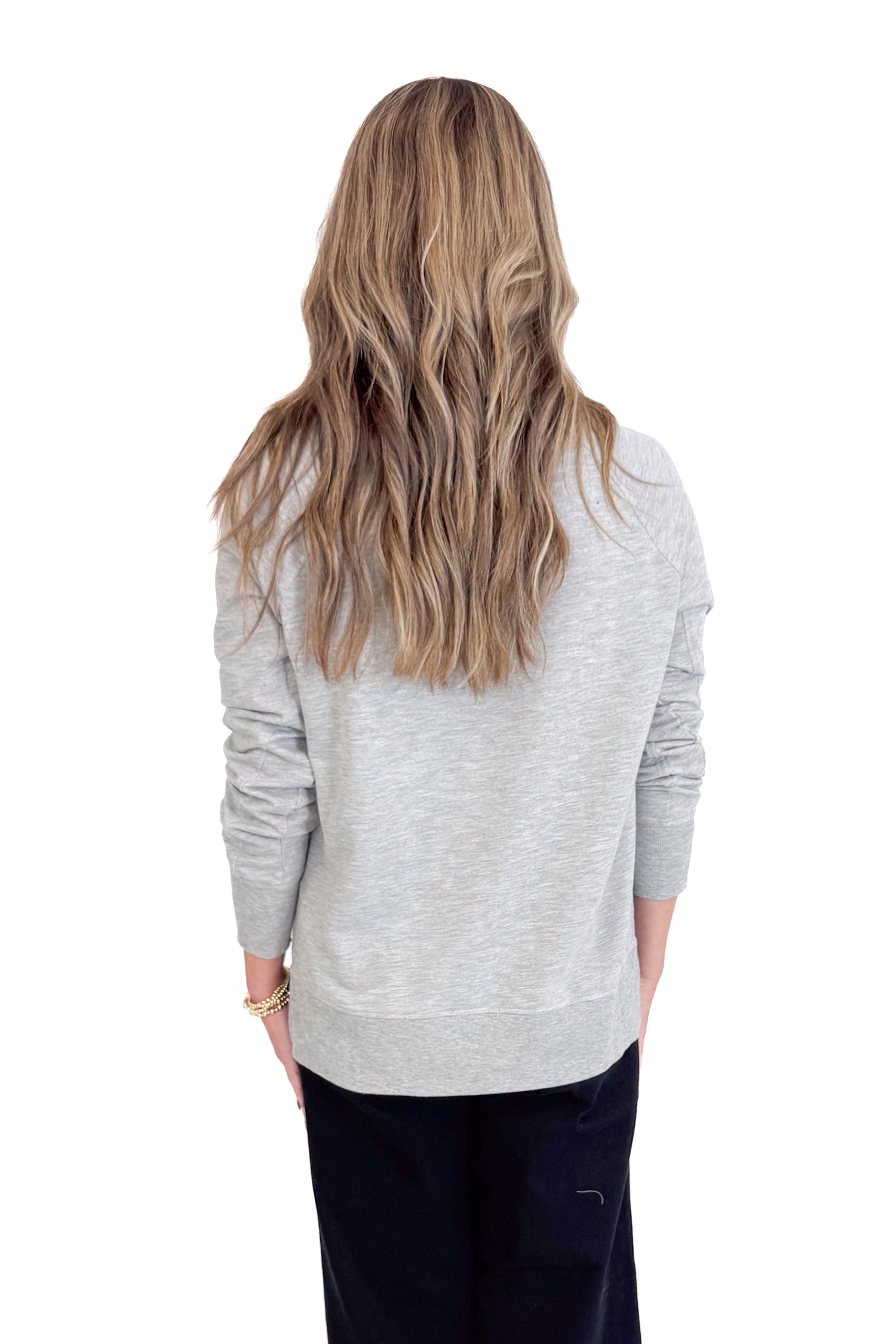 Person wearing a gray sweater from behind on a white background