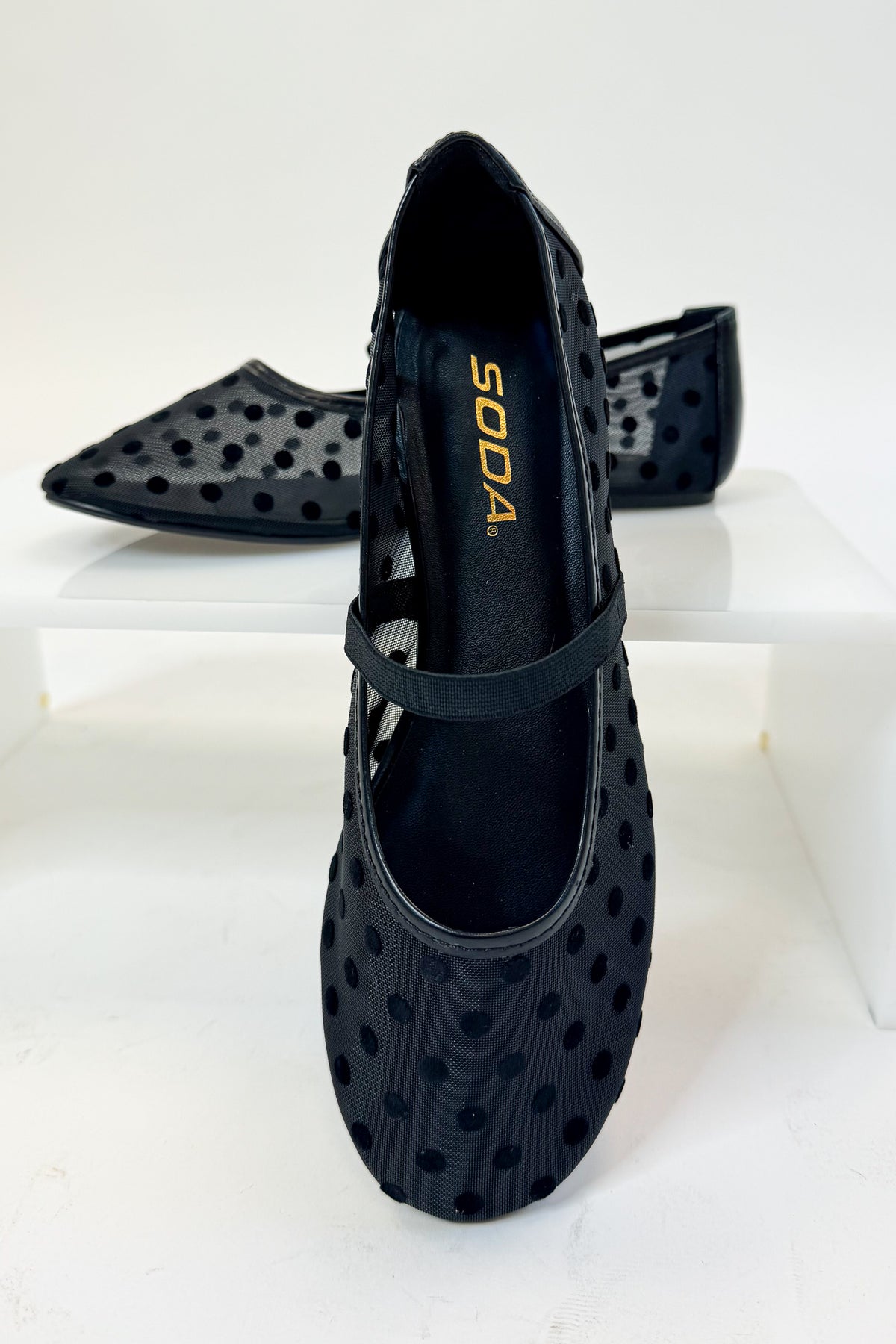 Zenda- Black Polka Dot Mesh Flat against studio background