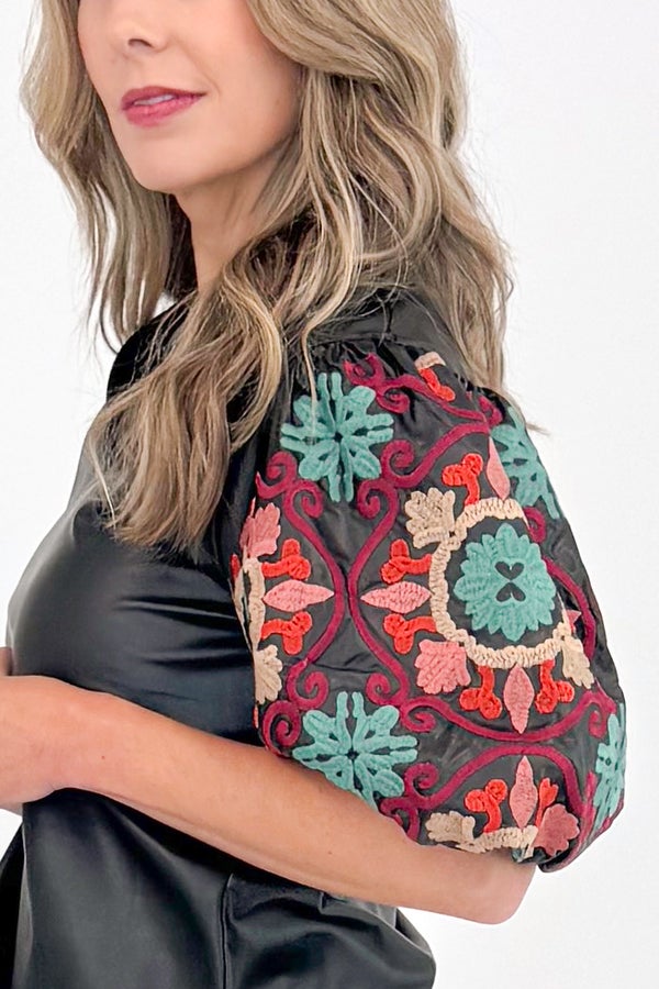 New Dawn black faux leather top with embroidered sleeves - side sleeve detail view on model