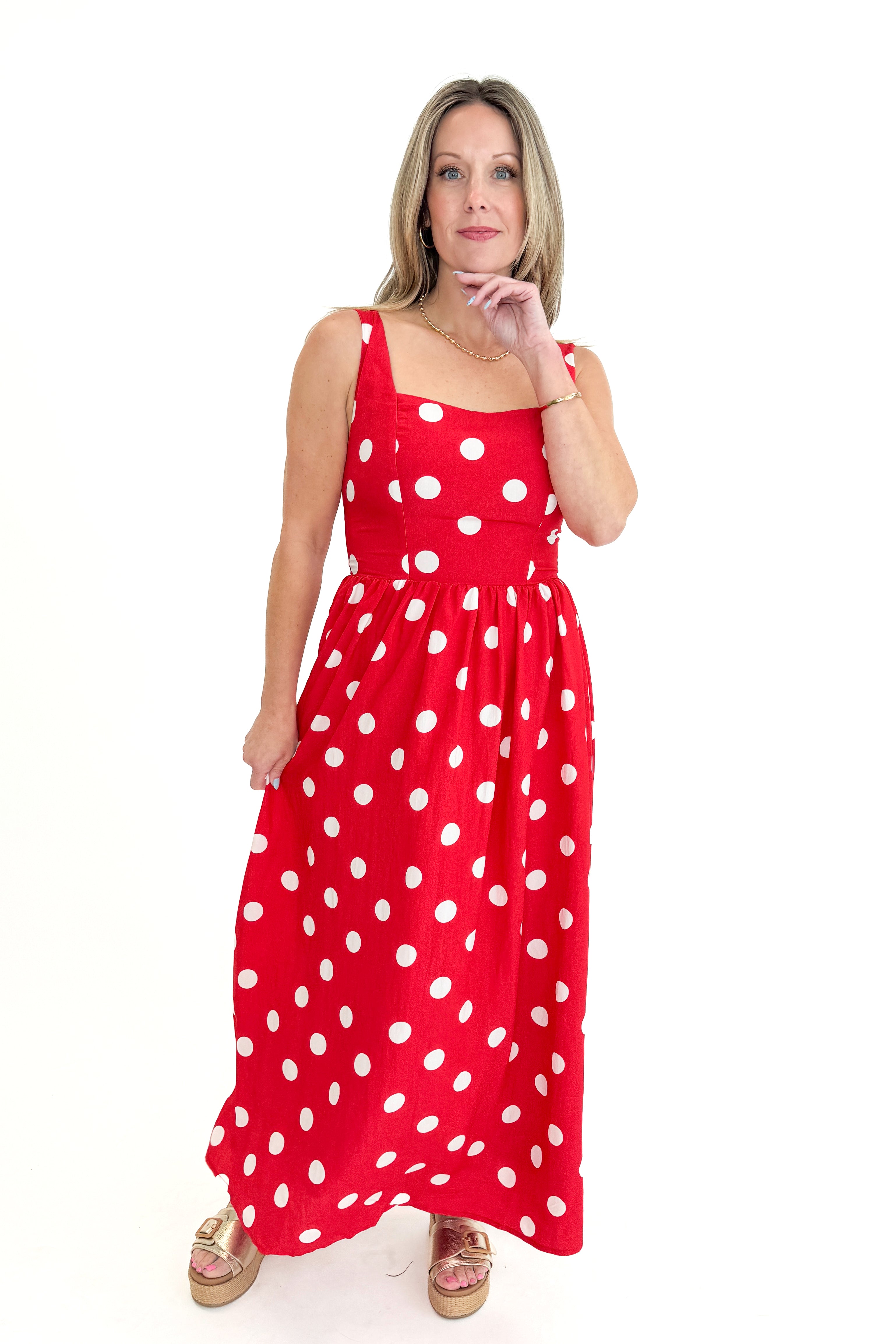 Front view of woman wearing Red & White Polka Dot Midi Dress against white studio background.